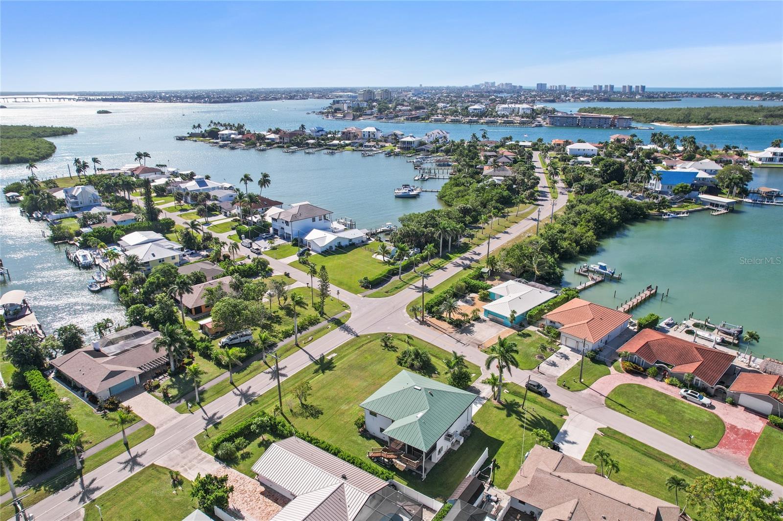 Welcome to 103 Tahiti Circle, where you can escape to the laid-back charm of Old Florida Tropical Paradise on the Isles of Capri! This home is elevated and situated on a large corner lot offering 3-bedroom, 3-bath and 1,775 square feet of bright, open living space, and nearly 1800 sq. ft. of garage and workshop on the ground level. With some updates and TLC the potential & dreams for this home could be endless! This property is perfect for relaxation, entertaining, and soaking in the island lifestyle. Open-concept layout upstairs with water views that invite natural light and breezy coastal vibes. Oversized lot provides endless potential to create your personal paradise — imagine a resort-style pool, tropical landscaping, or your own private retreat. Location, Lifestyle & Leisure, The Isles of Capri is a true hidden gem! A tight-knit community surrounded by scenic waterways, world-class fishing, and direct Gulf access. Just moments to Collier Boulevard Park Boat Ramp, Caxambas Park Boat Ramp, and three beloved local restaurants right on the island, offering delicious coastal dining with unbeatable sunset views. Whether you’re a boating enthusiast, fisherman, or simply someone who loves the serenity of island living, this home offers the perfect canvas to create your Florida dream. Located in Unincorporated Collier County and all just minutes to Marco Island and a short drive to downtown Naples beaches, shopping, and dining. Make this your dream home, short term rental, or investment opportunity – the possibilities are endless for this one of a kind property on Isle of Capri.