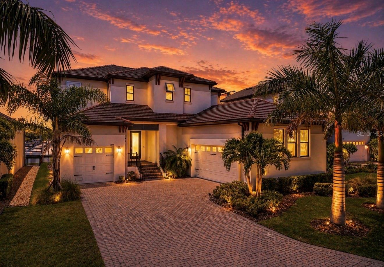 Experience elevated coastal living in the exclusive gated waterfront community of Antigua Cove, where luxury, boating, and breathtaking marina views come together in one extraordinary residence. Built in 2022, hardly lived in and perfectly positioned with direct access to Tampa Bay and the Gulf with NO FIXED BRIDGES, this stunning waterfront completely turn key home offers the ultimate Florida lifestyle just moments from open water, waterfront dining, and the marina.

Spanning 3,517 square feet, this light-filled residence features 4 bedrooms, 3.5 bathrooms, a spacious loft, bonus flex room/optional 5th bedroom, private elevator, and a thoughtfully designed layout ideal for both everyday living and effortless entertaining. From the moment you step inside, soaring ceilings, expansive sliding glass doors, and panoramic marina views create an immediate sense of luxury and tranquility.

The open-concept living space seamlessly connects the great room, dining area, and chef’s kitchen, all framed by the stunning waterfront backdrop. Designed for entertaining, the kitchen features an oversized island, gas range, abundant cabinetry, designer finishes, and a stylish dry bar with additional storage. The indoor-outdoor flow captures the essence of coastal living, with natural light pouring in from every angle.

The first floor includes a private guest suite with en-suite bath, an additional flex space perfect for a home office, gym, or optional 5th bedroom, powder bath, generous storage, and elevator access to the second level as well as to the garage. The unique split 3-car garage configuration offers exceptional flexibility for vehicles, golf carts, water toys, or even future lift storage thanks to the soaring ceiling height.

Upstairs, the expansive loft leads to a luxurious primary retreat where sweeping marina views and unforgettable sunsets become part of your daily routine. Step onto the private waterfront balcony directly from the primary suite and enjoy morning coffee or evening wine overlooking the boats below. The spa-inspired primary bath features a soaking tub, oversized walk-in shower with multiple shower heads, dual vanities, and a large walk-in closet. Two additional guest bedrooms, a full bath, and upstairs laundry complete the second level.

Outside, enjoy a covered waterfront lanai, private dock, and backyard space perfectly positioned to embrace the boating lifestyle. For added convenience, the Freedom Boat Club is located directly at the marina, offering effortless access to the water without the maintenance of boat ownership.

Antigua Cove residents enjoy a gated luxury waterfront lifestyle with community amenities including a clubhouse with community pool within walking distance and yacht club, all conveniently located near Little Harbor, downtown Tampa, St. Petersburg, and some of the area’s best boating destinations. Whether you are searching for a full-time waterfront residence, seasonal escape, or luxury coastal vacation retreat, this exceptional home delivers the rare combination of modern construction, marina-front living, and timeless coastal elegance.

This is more than a home—it’s a waterfront lifestyle designed for those who want to experience the very best of Tampa Bay living. All you have to do is show up with your boat! Opportunities like this rarely come available in Antigua Cove—schedule your private tour today and experience waterfront luxury living at its absolute finest.