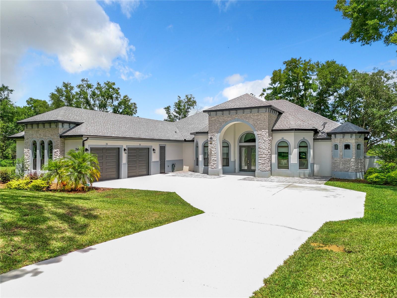 Short Sale. Discover a rare opportunity to own a 2022 custom-built pool home offering low-maintenance living, situated on 2.67 acres with a horse barn and a low HOA (community-managed, not property managed), all just minutes from the Turnpike for easy commuting. Perfectly positioned near major growth and lifestyle hubs, this home is located close to the upcoming Crooked Can Minneola development, the new Advent Health Minneola Hospital, and just 8 minutes from Montverde Academy. It is also zoned for the brand new Minneola Horizon Academy (K-8), known for its focus on aviation, aerospace, engineering, and STEAM education. Set along Lake Apopka in Clermont, this exceptional lakefront estate offers a unique blend of luxury, space, and functionality at an incredible value. The property’s impressive curb appeal and beautifully landscaped grounds welcome you into an expansive open-concept interior, featuring soaring ceilings and oversized windows that flood the home with natural light while capturing breathtaking nature and sunset views. The gourmet kitchen is a true centerpiece, complete with top-of-the-line appliances, custom cabinetry, and a large center island, perfect for entertaining. The living and dining areas seamlessly extend to an outdoor retreat, showcasing a saltwater pool, heated spa, and fully equipped outdoor kitchen, ideal for hosting unforgettable gatherings. The covered lanai also features a state-of-the-art TyloHelo CarbonFlex far-infrared sauna. The luxurious primary suite offers panoramic views, a spa-like en suite bath with a garden tub, and two expansive custom walk-in closets. 4 additional bedrooms provide comfort and privacy, including 2 with en suite bathrooms and one with direct access to the lanai and pool. Additional highlights include a water softener system and two tankless water heaters. Equestrian enthusiasts will appreciate the charming barn and open space, perfect for horses and riding. With its rare combination of acreage, direct lake access, upscale amenities, and a prime location near major developments and top-rated schools, this property truly delivers the best of Florida luxury living. Don’t miss this incredible opportunity, schedule your private showing today and be sure to check out the virtual tour!