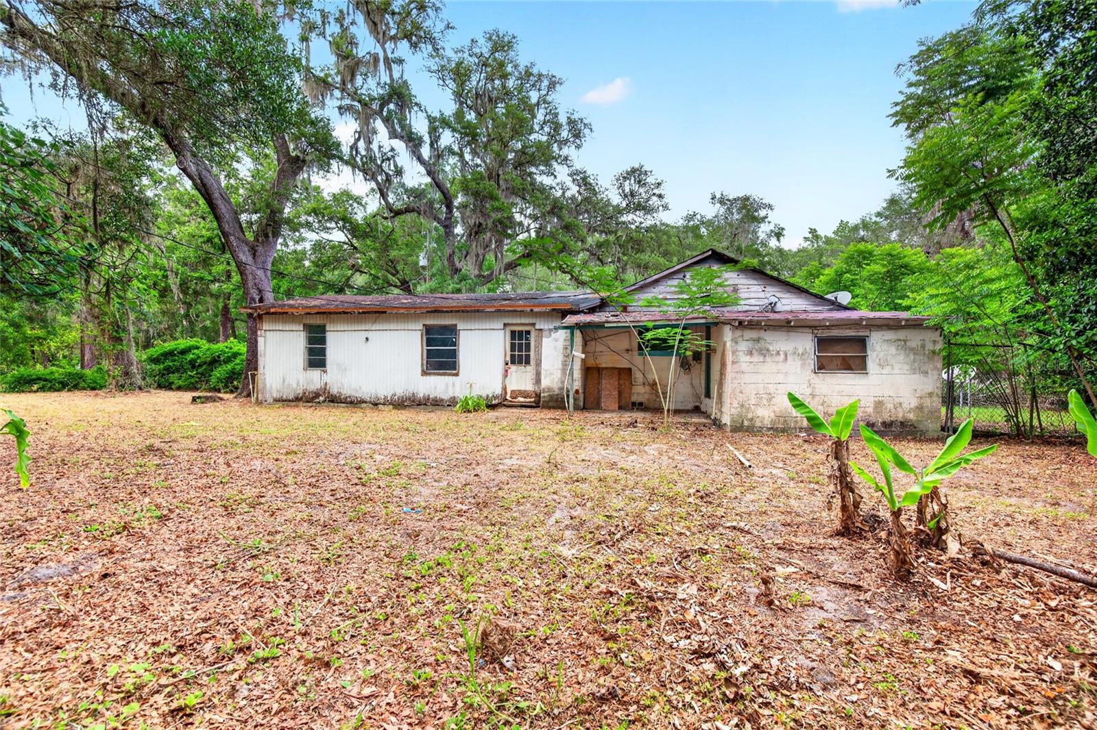 Virtually Staged. INVEST NOW in this solid BLOCK HOME on 1/2 an acre.  Make this your home or even better......Make this a DUPLEX!   Rent one half and live for FREE in the other. 1797 SQ FT plus a covered back porch__Enjoy the benefits of being in the A-1 Zone & being 875 Feet from Eureka West Recreation Area BOAT RAMP & Fishing Pier.  The partially fenced yard boasts a HUGE mature FIG TREE , mature OAKS,  lemon & citrus trees.   NO HOA- NO LOT RENT- NO FLOOD ZONE.  This house has no utilities CASH ONLY .   Remodel the house & the chicken coop & have your own private getaway in the forest.
Located in an area known for fishing, hunting, 4-wheeling, horseback riding & beautiful natural springs.  Some photos are virtually staged to show the potential of the home