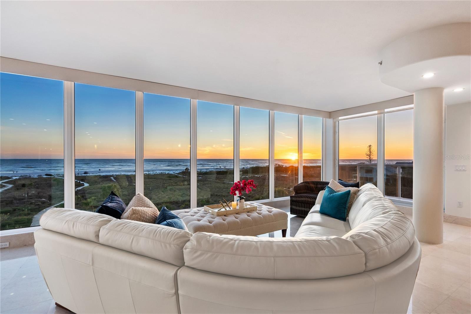 Exquisite Gulf-front penthouse, a private full-floor residence near Siesta Key’s pristine sands. Immerse yourself in the ultimate coastal luxury lifestyle with this spectacular Gulf-front penthouse, in an exclusive 3-residence boutique building, where each home occupies its private floor. Just near the world-renowned powdery quartz sands of Siesta Beach, this one-of-a-kind 3-bedroom, 3.5-bath residence offers breathtaking, unobstructed panoramic views of the azure Gulf waters and vibrant sunsets from nearly every room. Designed for the beach-loving connoisseur, this exceptional home features 3 spacious bedrooms, including 2 private suites, each with spa-inspired baths and floor-to-ceiling windows showcasing endless Gulf vistas. A second-story bonus room with a half bath provides a versatile space ideal for a media room, home office or guest retreat, all while offering stunning rooftop views. From the moment you get off the private-stop elevator directly into your full-floor residence, you’re met with sweeping Gulf views framed by walls of glass, filling the interiors with natural light and seamless indoor-outdoor ambiance. The expansive open-concept living space is ideal for everyday living and entertaining. The gourmet kitchen is a chef’s dream, featuring premium appliances, sleek modern cabinetry and elegant stone countertops. Travertine and rich wood flooring add warmth and refinement throughout. The magnificent rooftop terrace offers complete privacy for sunbathing, entertaining, or unwinding while enjoying soothing sea breezes and postcard-worthy sunsets. Additional luxury amenities include a secure lobby, a rare 2-car tandem garage with private driveway and private elevator access, delivering the comfort and privacy typically found only in single-family beachfront estates. On ground level, an inviting shaded outdoor lounge and dining area with a built-in grill creates the ideal setting for alfresco meals under the stars, all just a short distance along a private shell path to the soft white sands of Siesta Beach. Beyond the beach, enjoy the vibrant energy of Siesta Village, with boutique shopping, fine dining and lively nightlife just minutes away. If you value privacy, exclusivity and full-floor living paired with direct beach access, this extraordinary penthouse presents a rare opportunity to own one of Siesta Key’s most desired Gulf-front residences.