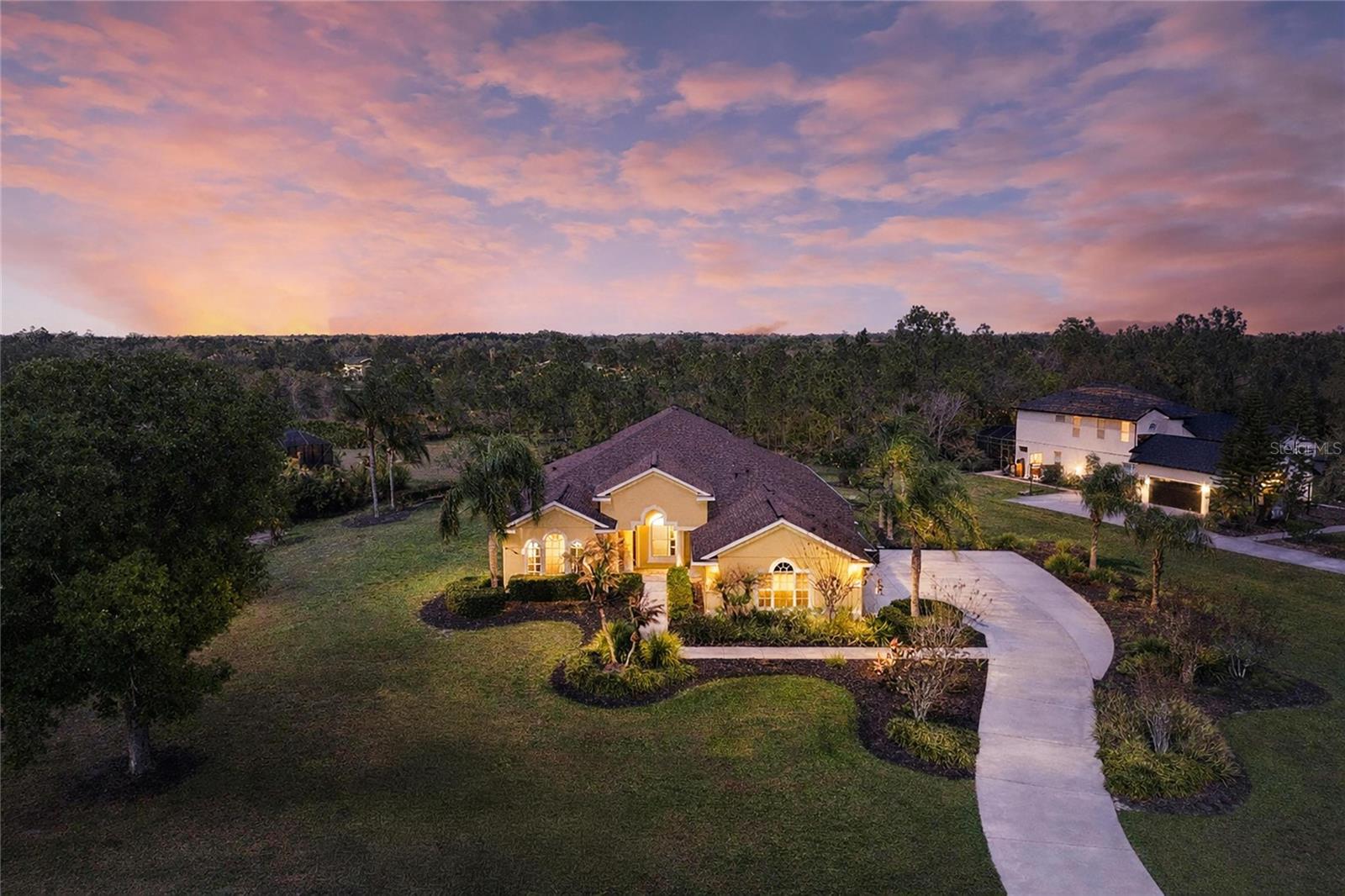 Located in the highly sought-after Preserve at Panther Ridge, this pristine home offers exceptional privacy, space, and beautiful natural surroundings. From the moment you enter, it is clear the home has been meticulously maintained.

A spacious private office sits at the front of the home and features a large window overlooking the beautiful front yard. The welcoming dining room is bright and elegant, highlighted by a tray ceiling and abundant natural light. The living room provides a comfortable space for gathering with guests, while the family room features large sliding glass doors that seamlessly bring the outdoors in.

The open-concept design flows effortlessly into the kitchen, which is beautifully appointed with granite countertops, new stainless steel appliances, two pantries, a central island, breakfast bar, and a kitchen dining area with stunning aquarium windows overlooking the backyard.

The spacious primary suite offers peaceful views of the gorgeous backyard and is privately located on its own side of the home. The primary bathroom features dual sinks, a large walk-in closet, a garden tub, and a walk-in shower. Bedrooms two and three share an updated bathroom with floor-to-ceiling tile and granite countertops. The fourth bedroom is privately situated and features its own bathroom that also provides convenient access to the pool area.

Upstairs, a large bonus room offers endless possibilities and is perfect for a media room, game room, pool table, or play area.

The outdoor living space is truly the highlight of the home. The extended paved pool deck provides plenty of room for lounging and outdoor dining. Surrounded by beautiful pine trees and natural landscaping, the backyard offers a peaceful setting to enjoy sunsets and Florida nature.

The Preserve at Panther Ridge is a vibrant community featuring “A” rated schools, scenic walking trails, lakes, tennis courts, a basketball court, and playgrounds. The neighborhood is conveniently located near the UTC Mall, Lakewood Ranch Main Street, numerous fine dining options, and Florida’s world-renowned Gulf beaches. Tampa International Airport is approximately 50 minutes away, and Sarasota-Bradenton International Airport is about 30 minutes away. With NO CDD fees and LOW HOA dues, this property offers the perfect blend of privacy, convenience, and lifestyle.
*Roof 2023, A/C 2025,Upstair carpet 2024, Generator hookup, Bathrooms remodeled 2025, Water Softener 2023, Refrigerator 2024, Microwave 2026, and Cooktop 2026, refrigerator 2026.