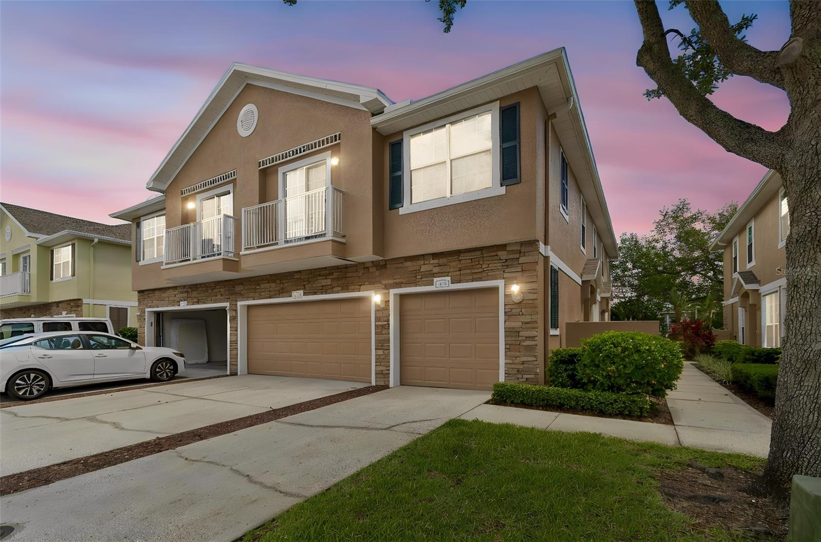 Welcome to Bay Breeze Cove, where low-maintenance living meets everyday convenience in one of St. Petersburg’s most desirable neighborhoods. This beautifully maintained double corner unit offers 2 bedrooms, 2 bathrooms, 1,200 square feet, a private side entrance, an attached garage, and a bright second-floor layout and does NOT REQUIRE FLOOD INSURANCE. Inside, soaring ceilings and abundant natural light create an open, airy feel. The living and dining areas feature two sets of double sliders opening to separate balconies for seamless indoor-outdoor living. The kitchen provides generous counter space, a pantry, a built-in desk, and smooth flow into the main living areas. The split-bedroom layout includes a primary suite with a walk-in closet and en-suite bath, plus a versatile guest bedroom next to a full bath. A full-size laundry room adds everyday convenience. Major recent upgrades including 2025 roof, HVAC 2020, water heater 2018, and fresh exterior paint in 2025 support long-term value and peace of mind. The community offers landscaped grounds, a serene newly renovated key-fob-access pool, a dog park, and a peaceful walking loop around a fountain pond. Ideally located just 3 miles from Downtown and steps to 4th Street shops and dining and minutes to Whole Foods, Publix, Fresh Market, Trader Joe’s, the beaches, Tampa, and major commuter routes, Bay Breeze Cove delivers the best of comfort, convenience, and St. Pete living.