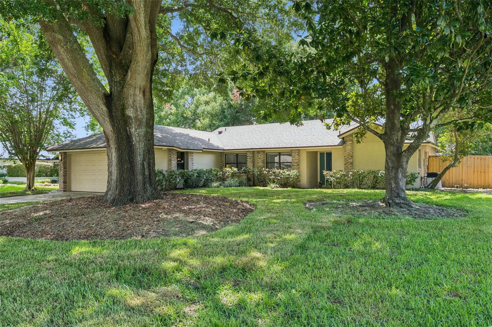 WELCOME HOME! Nestled beneath majestic oak trees in one of Windermere's most desirable communities, this well-maintained 3-bedroom, 2-bath home sits on a quarter of an acre and offers the perfect blend of comfort, privacy, and location. Situated in the highly sought-after 34786 zip code, this exceptional residence features a popular split-bedroom floor plan with 1,819 square feet of thoughtfully designed living space. Silver Woods is located in the center of SW Orlando, close to Downtown Windermere, Restaurant Row, Winter Garden Village, Downtown Winter Garden, churches, schools, shopping, and more.   As you enter the front door, you will be impressed with the open floor plan.   New paint, new carpet, and neutral tile create a light and bright environment. Step inside to discover spacious living and dining areas that flow seamlessly into the heart of the home. The living room looks out onto the huge patio and backyard. The kitchen offers abundant cabinetry, granite countertops, ample workspace, and overlooks the main living areas, making it ideal for everyday living. Enjoy the family room, which opens to a covered, screened lanai via sliding doors, creating an incredible outdoor living space perfect for relaxing, entertaining, or simply enjoying the tranquil backyard surrounded by mature trees. The oversized, park-like shared fenced backyard provides exceptional privacy and plenty of room for gardening, play, or creating your own outdoor oasis. Let your imagination create the perfect Pool/Spa area with a summer kitchen, fire-pit, and more. The primary bedroom features sliding doors to the expansive lanai, and the en-suite features a Tub, a newer double-sink vanity, and a walk-in shower.  A split-bedroom plan is perfect for today's busy family, featuring two bedrooms and a hall bath with a shower/tub.   Recent improvements, including a NEW ROOF,  HVAC (2016), New Garage Door (2016), Septic (2021), Electric Panel (2017), Interior paint (2026), Front Sod (2026), and  Carpet (2026) in the main living areas, make this home move-in ready while still offering opportunities for a new owner to personalize and add value over time. The community offers a park and a tennis court for the residents.  Ideally located just minutes from top-rated Windermere schools, shopping, dining, churches, world-famous theme parks, major highways, and Orlando's many entertainment destinations, this home offers the perfect balance of peaceful neighborhood living and everyday convenience.  Don't miss your chance to make this Windermere gem your next home- schedule your private showing today!