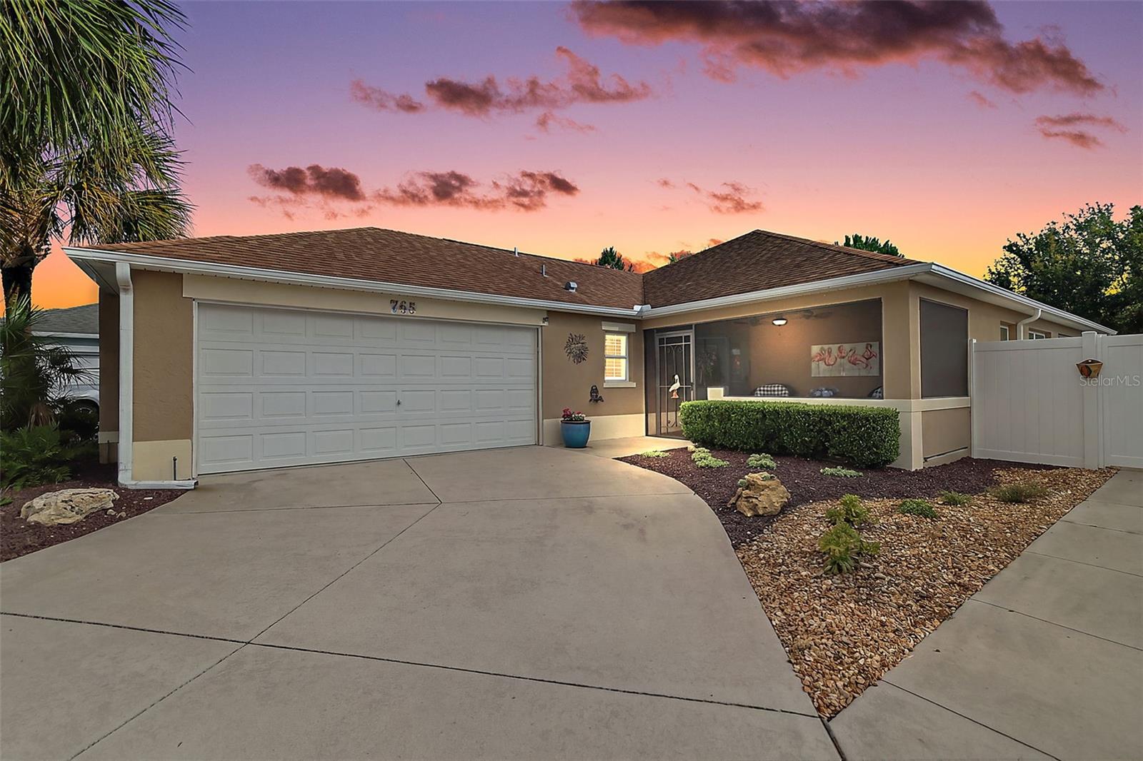 Welcome to this METICULOUSLY-MAINTAINED, BLOCK and STUCCO 3-bedroom, 2-bath Avondale courtyard villa where MODERN ELEGANCE meets OUTDOOR SERENITY! This INCREDIBLE home boasts a TWO-CAR GARAGE (rare in a villa), SCREENED LANAI, and FABULOUS 40’x21’ PATIO with PERGOLA and LOW-MAINTENANCE, STONED front, side, and rear yards - NO GRASS - perfectly situated on a LARGE, PRIVATE, CORNER LOT with ROOM FOR A POOL in the Village of Pine Ridge! A QUAINT SCREENED front porch with EPOXY PEBBLE floor and BEAUTIFUL LEADED GLASS door and side light welcome you in to the bright, generous foyer with LUXURY VINYL PLANK flooring running seamlessly throughout the ENTIRE home. ADDITIONAL UPGRADES include PLANTATION SHUTTERS, CUSTOM CORNICES, EXTENDED BASEBOARDS, MODERN LIGHTING and FANS, and a BRAND NEW WHOLE-HOUSE GENERAC! The OPEN CONCEPT floor plan and HIGH VAULTED ceilings of the living, dining, and kitchen create a SPACIOUS main area - perfect for entertaining friends and family! The AMAZING kitchen showcases GORGEOUS NATURAL LINEN cabinetry, GRANITE countertops, TILE backsplash, STAINLESS STEEL appliances, Induction Cooktop Stove, BUILT-IN PANTRY with ROLL-OUT SHELVING, and an EBONY CENTER ISLAND with EAT-IN area. The adjacent dining and living rooms feature multiple windows and two sets of sliding glass doors for an ABUNDANCE of NATURAL LIGHT. From either of these rooms, enter into the SCREENED LANAI with EPOXY PEBBLED floor and ceiling fan. This wonderful room opens to the PRIVATE, FULLY-ENCLOSED rear and side courtyards featuring an EXPANSIVE PATIO with ELEGANTLY DESIGNED PERGOLA. This FANTASTIC outdoor area boasts enough ROOM FOR A POOL and offers a TRANQUIL, PRIVATE space for outdoor dining, entertaining, or simply relaxing and enjoying the BEAUTIFUL Florida weather! Back inside, retreat to the primary bedroom showcasing a TRAY ceiling, CUSTOM WALK-IN closet, and DOUBLE windows. Its en-suite bathroom features CINNAMON cabinetry, DUAL sinks, TILED ROMAN-STYLE WALK-IN shower, and a separate water closet. Bedroom two features a VAULTED ceiling and built-in closet while the updated second bathroom boasts a contemporary BARN DOOR entry, NATURAL LINEN vanity, TILED WALK-IN shower with FRAMELESS glass, and a hall LINEN closet. The third bedroom with a large window, SOLAR TUBE and built-in closet showcases CUSTOM, BUILT-IN, WHITE cabinetry with DESK, SHELVING, and MURPHY BED. This VERSATILE ROOM offers the ideal space for a home office, craft room, den, and/or additional sleeping area. Completing the package is a 23’x19’ TWO CAR GARAGE with EPOXIED floor, convenient laundry nook, white cabinetry, utility sink, suspended storage shelving, and attic access with stairs. DON’T MISS YOUR OPPORTUNITY TO MAKE THIS INCREDIBLE HOME YOUR OWN! The Village of Pine Ridge is IDEALLY LOCATED near both Lake Sumter Landing and Brownwood Paddock Squares. Close to Belle Glade Country Club and Championship Golf Course; Colony Cottage Regional Recreation Center; Sarasota Golf Practice Facility; Sharon Rose Wiechens Nature Walk and Preserve; Atlas Dog Park; and Colony Plaza and CR 466A with an abundance of shopping, dining, banking, medical, and more! PLEASE WATCH OUR WALKTHROUGH VIDEO of this FABULOUS HOME IN AN AMAZING LOCATION and call today to schedule your Private Showing or Virtual Tour!