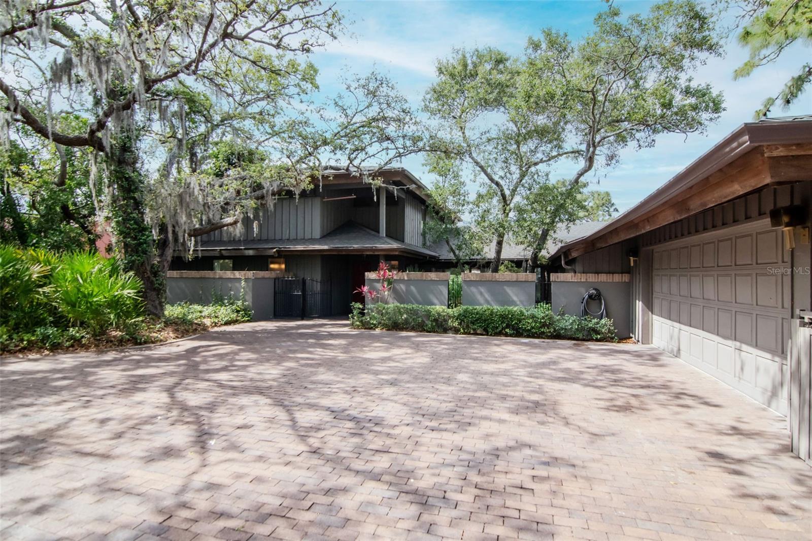 A rare opportunity to own a substantially renovated luxury waterfront estate in the highly sought-after Weybridge Woods community of Dunedin. Perfectly positioned on approximately 100 feet of Curlew Creek waterfront with direct access toward the Gulf.
Offering approximately 3,685± square feet, the home features 4 bedrooms, 4.5 bathrooms, two luxurious primary suites, a private office, multiple living and entertaining areas, and an exceptionally flexible floor plan ideal for multigenerational living, executive retreats, or hosting family and guests.
Originally custom-built by a builder for his own family, the residence was engineered with extraordinary structural integrity, including deep structural steel beams extending into the ground for lasting stability, a level of construction rarely found today. Nearly $200,000 in recent improvements include a new roof, four newer HVAC systems, luxury flooring, designer lighting, an expanded primary suite, beautifully renovated bathrooms, and numerous additional high-end upgrades throughout.
Inside, soaring cedar ceilings, skylights, walls of glass, multiple fireplaces, and breathtaking panoramic water views fill the home with warmth and natural light. The beautifully renovated chef’s kitchen flows seamlessly into spacious living and dining areas designed for effortless entertaining, complemented by a wet bar, wine refrigerator, and spectacular waterfront views.
Both primary suites offer spa-inspired comfort, generous closets, and exceptional privacy. Spacious guest suites, a dedicated office, and versatile flex spaces easily accommodate today’s evolving lifestyle.
Step outside into your own private waterfront sanctuary surrounded by mature trees, lush tropical landscaping, and abundant native wildlife. Launch a kayak or paddleboard from your backyard, fish along the shoreline, entertain in the outdoor grilling area, or simply relax while enjoying spectacular sunrises and the peaceful beauty of Curlew Creek. This remarkable property offers the feeling of a private nature preserve while remaining just minutes from every modern convenience.
Weybridge Woods is one of Dunedin’s most distinctive and sought-after neighborhoods, celebrated for its rolling hills, majestic oak canopy, scenic waterways, oversized homesites, and architecturally unique custom homes, an extraordinary setting unlike anywhere else in Pinellas County.
Minutes away, Downtown Dunedin offers one of Florida’s most charming and walkable waterfront districts, celebrated for independently owned boutiques, award-winning restaurants, artisan cafés, craft breweries, galleries, waterfront parks, farmers markets, festivals, live music, and year-round community events. Unlike many surrounding communities, Dunedin has carefully preserved its authentic coastal village atmosphere creating a vibrant lifestyle rich in local character, culture, and charm.
Renowned Pinellas Trail, one of Florida’s premier recreational trails, offering miles of scenic cycling, walking, and running through downtown Dunedin while connecting to waterfront parks, beaches, and neighboring coastal communities. Nearby are the historic Dunedin Golf Club, marinas, waterfront parks, the pristine shores of Honeymoon Island State Park and Caladesi Island State Park, award-winning Gulf beaches, boating, fishing, tennis, pickleball, and endless outdoor recreation.