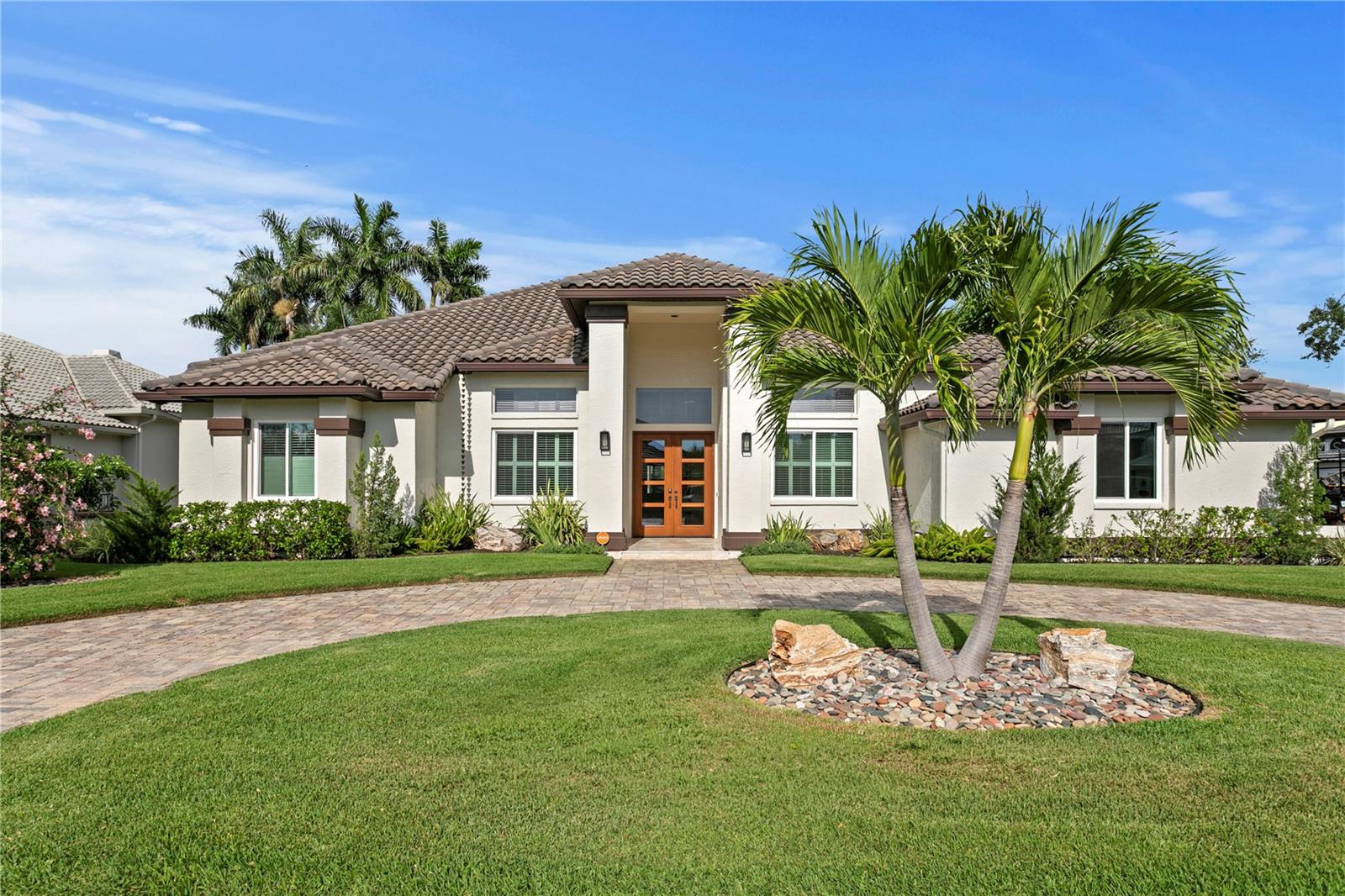 Tucked away at the end of a quiet cul-de-sac within the guard-gated community of Placido Bayou, this extensively renovated estate offers a rare combination of privacy, space, and modern luxury. Situated on an extraordinary .55-acre homesite measuring approximately 93’ x 190’, this is one of the largest residential lots in the neighborhood.  Completely updated in 2023, the residence spans 4,254 square feet and features 5 bedrooms, 4 full baths, and 1 half bath, with thoughtfully designed indoor and outdoor living spaces ideal for both everyday living and entertaining. Elevated at approximately 8 feet and never flooded, the home provides peace of mind along with exceptional comfort. The resort-style backyard was transformed in 2023 with a gas-heated saltwater pool and spa, travertine pool deck, outdoor kitchen, covered entertaining areas, steam sauna, Sonos sound system, and lush professional landscaping. A detached climate-controlled gym/casita offers incredible flexibility as a fitness studio, private office, guest retreat, or creative space. Inside, the home showcases a beautifully updated kitchen with quartz countertops, premium appliances, and seamless flow to the club room and poolside entertaining areas. Additional upgrades include hurricane-rated windows and doors, tankless water heater, EV charging capability, security system with cameras, epoxy garage flooring, and fenced green space for pets and play. Placido Bayou is one of St. Petersburg’s most sought-after gated communities, known for its mature oak-lined streets, scenic lakes and ponds, neighborhood events, and convenient access to downtown St. Petersburg, Tampa International Airport, and Clearwater Beach. Rarely does a property combine this level of privacy, lot size, elevation, and extensive recent renovation in one of Northeast St. Petersburg’s premier gated neighborhoods.