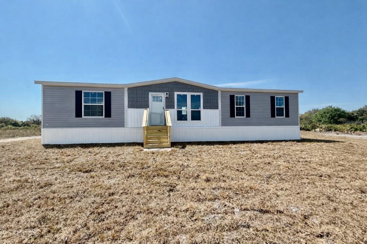 Brand New 3BR/2BA Home on 1.25 Acres in the Prairie/Viking area, not far from the paved road, featuring a 1-year manufacturer warranty and seller offering a credit toward buyer’s closing costs with acceptable offer. This beautifully upgraded 1,493 SqFt Champion Embrace home features a modern split floor plan with warm wood tones, accent walls, and stylish contemporary finishes throughout. The spacious kitchen includes a large island, built-in microwave, coffee bar, and contrasting countertops. A dedicated dining area flows into the inviting living room, creating an open and comfortable space for everyday living. The private primary suite offers a relaxing retreat with a standalone soaking tub, oversized shower, and double vanity. Additional highlights stainless steel appliances, black fixtures, walk-in closets, and an interior laundry room with built-in cabinets and hanging rack. Situated on a 1.25-acre AG-zoned lot, this property provides plenty of room for animals, RVs, boats, or future additions like a barn, garage, workshop, or pool.  Should be ready in 30-60 days.