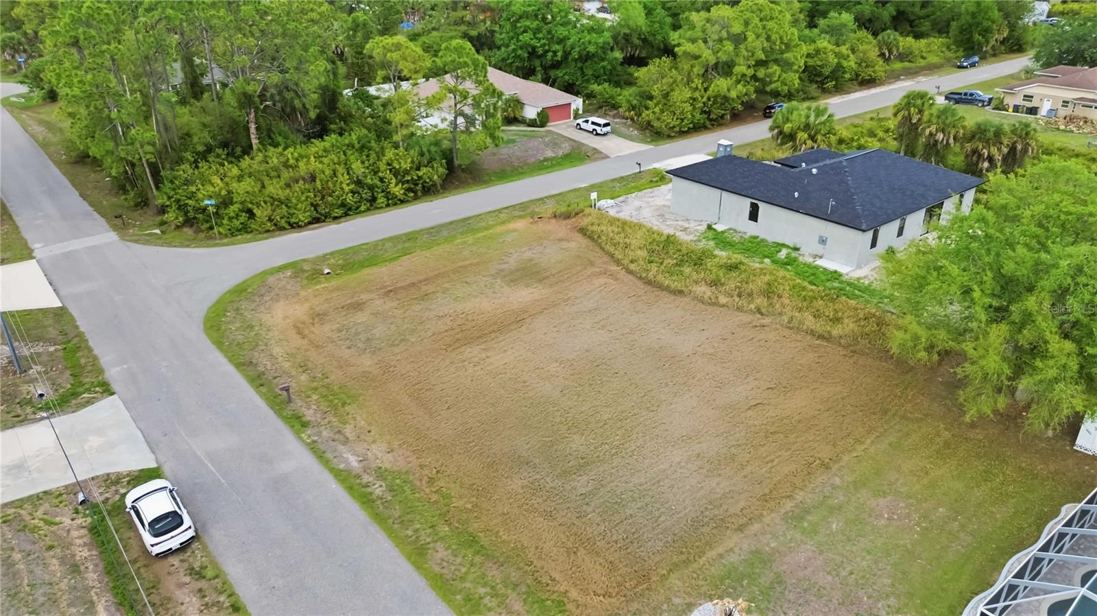 BUILD TODAY. NO WAITING. NO SURPRISES.
This cleared corner lot in North Port is truly ready for your builder — no clearing costs, no delays, and NO MITIGATION FEES. The hard work is already done.
Situated in a quiet pocket of North Port surrounded by newer construction, this property offers the rare combination of being shovel-ready in a neighborhood that's already growing. Corner positioning gives you dual frontage and the flexibility to orient your home facing north or west — a detail that matters more than most buyers realize when it comes to natural light, curb appeal, and resale value.
FLOOD ZONE X. NO FLOOD INSURANCE REQUIRED. Survey available — move straight into permitting and planning. Well and septic will be required, consistent with the area and easily planned into your build budget.
Conveniently located with quick access to US-41 and I-75, and approximately 8 miles from the shops, dining, and waterfront lifestyle of Downtown Wellen Park. The North Port Aquatic Center, local parks, and schools serving elementary through high school are all within approximately 3 miles (buyer to verify). Gulf Coast beaches are roughly 30 minutes away.