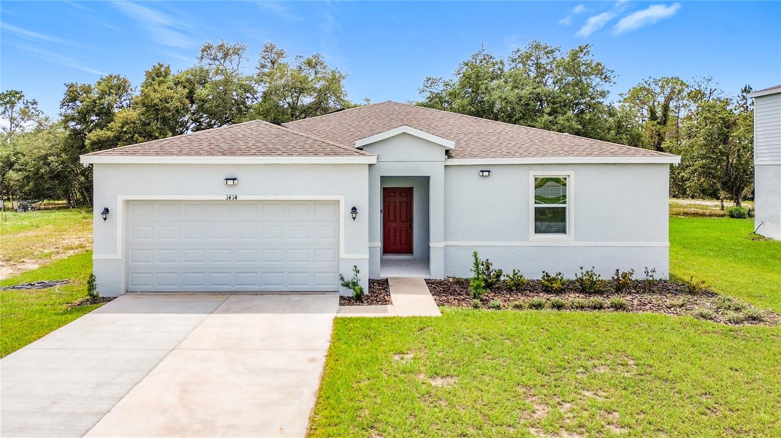 Welcome to West Village in Poinciana! If you're looking for a home that feels like new, offers a peaceful setting, and is conveniently located near shopping, dining, schools, and recreation, this one is a must-see. Plus, you'll enjoy the benefit of a low HOA and being just a few miles from beautiful Lake Marion.

Built in 2024 and meticulously maintained, this move-in-ready home still carries the builder's warranty for added peace of mind. It also features a water softener system, providing enhanced water quality and everyday convenience.

Step inside from the welcoming front porch and you'll immediately appreciate the home's functional layout. At the front of the home, you'll find three spacious bedrooms, a full bathroom with a double vanity and shower/tub combo, and a convenient walk-in laundry room.

As you continue through the home, the space opens up into a bright and airy living area that's perfect for both everyday living and entertaining. The kitchen overlooks the dining and great room and features a large island, ample cabinet space, and a pantry, making it easy to stay connected with family and guests while preparing meals.

Sliding glass doors lead to the backyard patio, creating a great spot to enjoy your morning coffee or unwind after a long day while taking advantage of Florida's beautiful weather.

Tucked away at the back of the home for added privacy, the primary suite offers a comfortable retreat with plenty of space to relax. The ensuite bathroom includes dual sinks, a large walk-in shower, and a spacious walk-in closet.

This beautifully maintained home shows like new and is truly move-in ready. Don't miss your opportunity to own a nearly new home with modern features, a water softener system, remaining builder warranty coverage, and an excellent location within the growing West Village community.