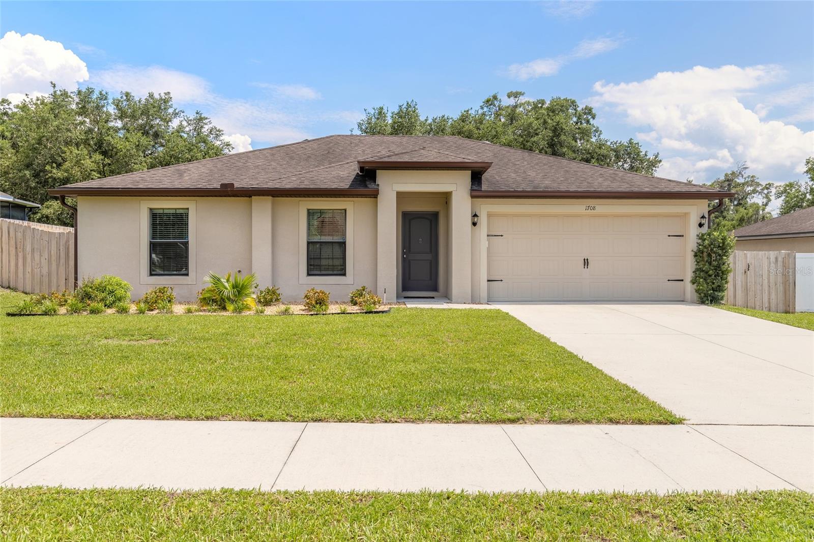 Welcome to this beautifully maintained  3 bedroom, 2 bath home offering functional open-concept layout designed for comfortable, everyday living. The kitchen is open to the living area, creating an inviting space for gathering. The kitchen features an island, pantry, black appliances and an eat-in dining area. The split bedroom floor plan provides privacy for the primary suite, which includes an en-suite bath with a walk-in shower. Additional features include an inside laundry room, with washer and dryer negotiable with an acceptable offer. Sliding glass doors lead from the living area to the fully fenced backyard, offering plenty of space for pets, play or outdoor enjoyment. Located in a quiet DeLand neighborhood, this home provides practical living spaces and pride of ownership throughout. Roof, AC, water heater 2018 (built 2018). All information deemed to be correct, but should be verified.