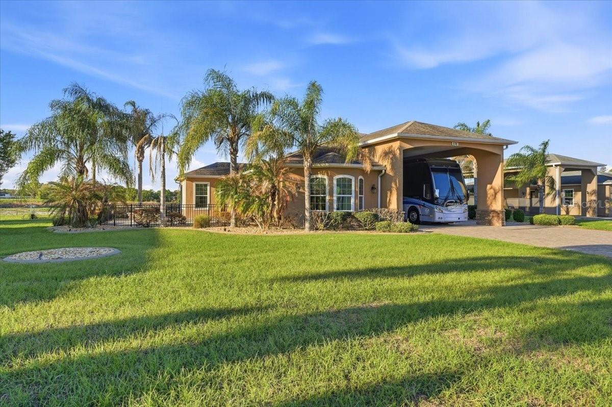 Are you dreaming of a cozy winter escape, or perhaps a charming year-round residence in a vibrant community? Look no further than this stunning 1 bedroom, 1 bath home nestled in the highly desirable Mt. Olive Shores North. Built in 2013 and situated on a generous double lot (approximately 150'x127'), this property offers the perfect blend of comfort, convenience, and Florida sunshine.

Imagine stepping inside to a bright and airy open floor plan. The kitchen seamlessly flows into a welcoming bar counter with chairs, perfect for casual meals and conversation. Beyond that, an extra-large living/dining room area provides ample space for relaxation and entertaining. Picture yourself hosting friends and family, creating memories that will last a lifetime.

But the beauty doesn't stop indoors. Step outside onto your own private, fenced-in patio, a cozy garden oasis with a built-in concrete table and benches. This is the ideal spot to unwind with a good book, enjoy al fresco dining, or simply soak up the Florida sunshine.

This meticulously maintained 1,235 sq ft home boasts beautiful wood grain ceramic tile throughout, creating a warm and inviting atmosphere. Custom honeycomb blinds and valances add a touch of elegance, while solar tube lighting in the kitchen and bath floods the spaces with natural light. A whole-house vacuum system makes cleaning a breeze.

The spacious master bedroom is a true retreat, featuring a beautiful bay window, a tray ceiling, his-and-her closets, and extra storage above for keeping everything organized. The laundry closet and main bathroom are conveniently located off the hallway, along with a dedicated office area complete with a built-in desk, storage, and shelving.

For the RV enthusiast, this property is a dream come true. The extra-wide RV port (55'x22') is equipped with both hot and cold water spigots. Behind the RV port, you'll find a 11'x14' storage area with extra-wide pull-down steps, providing even more storage space in the attic. The paver driveway offers ample parking, with extra space on the side.

Finally, the beautifully landscaped yard, complete with several fruit trees, adds the perfect finishing touch to this exceptional property.

This home is more than just a house; it's a lifestyle. Don't miss your chance to own this piece of paradise. Call today to schedule an appointment and experience the magic for yourself. You won't be disappointed!