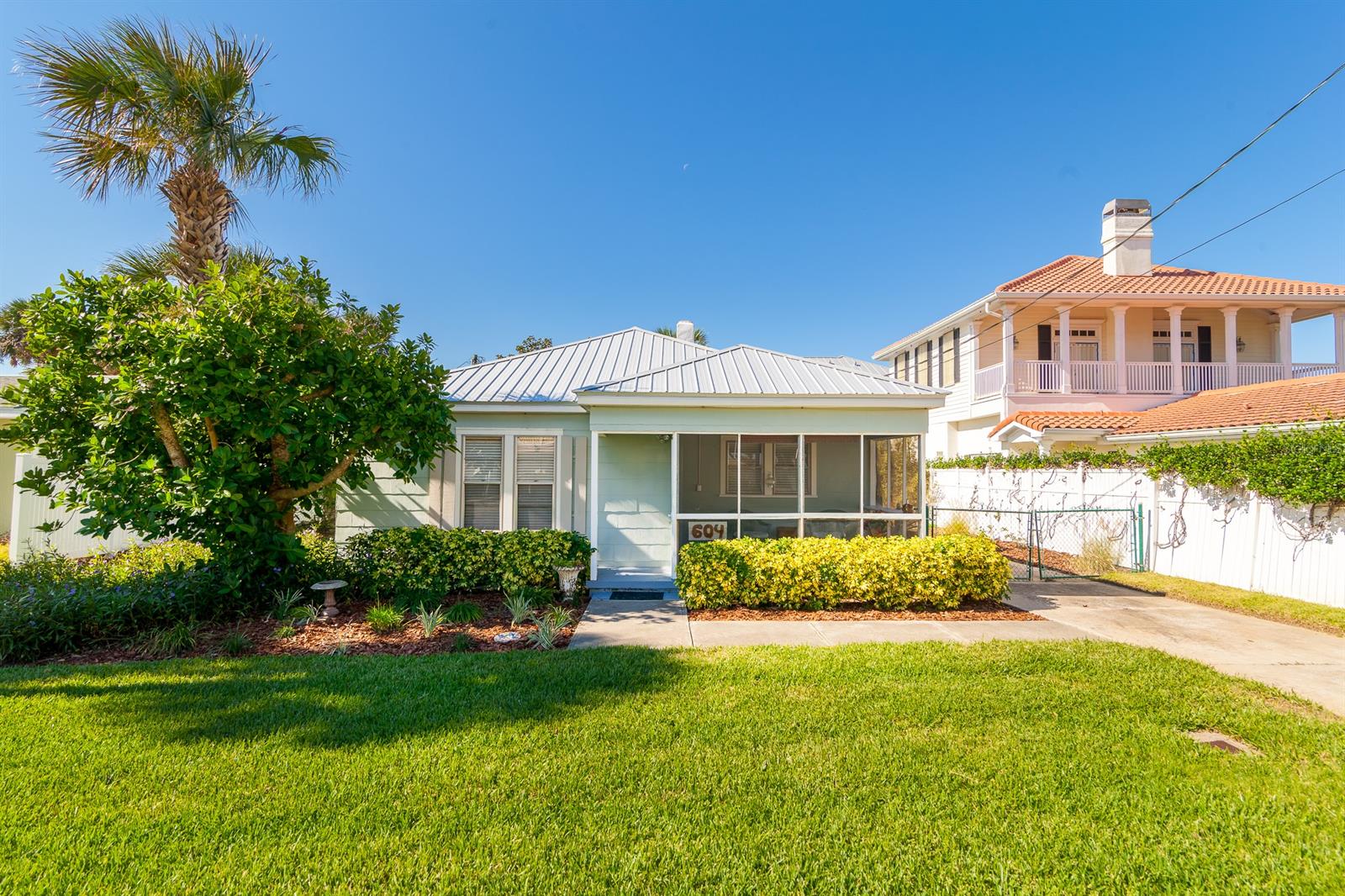 Located just across from the ocean & just around the corner from beach ramp, this quaint home is the perfect “little beachhouse”.   Lots of windows & wood floors add character & charm.  Screened front porch entry.  Eat-in kitchen with breakfast bar.   Walk-in closet in south bedroom.    Beautifully landscaped backyard with spacious paver patio, firepit & outdoor shower.  Detached garage.  Metal roof approximately 5 years old. Natural gas for central heat & water heater.   A multi-story addition would enjoy oceanviews!  Great location just six blocks from Flagler Avenue restaurants & shops.  Come see the possibilities!  Seller will negotiate some furnishings separately. ;Water: City