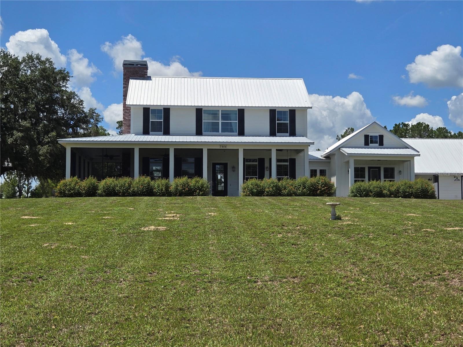 An unbelievable opportunity has become available in the quaint town of Clermont! If strolling or fitness is your hobby, this town has it all. A special place taking you back in time, while walking, running, and biking are available on the Clermont/West Orange Trail that goes right through the town. This special town is sprinkled with restaurants, merchandise boutiques, amazing lakefront dining and plenty of bakeries and ice cream stores to cure that sweet tooth. A local brewery is coming to town with special events while the mayor makes sure every holiday is celebrated, whether it’s decorated, has holiday music or fireworks!  While the town is nestled around the Clermont chain of lakes, you have easy access to major expressways and Themed Parks. This is Florida that meets new Florida for sure!!
Now get ready to visit your newer lakefront home 7956 Lake Nellie Road! A true country feel, as you travel to your little bit of paradise just waiting for your imagination.  With almost 5 acres of land, you can fulfill your dream of raising chickens or bringing your horse while still water skiing on your private Lake Nellie. Your dock is ready to add your floating docks to place your water toys!
As you drive to your impressive estate, expect to be impressed as your land sprawls over both sides of the road. As you pull in your long driveway, get ready for the magic of carefree living in your gently used 2019 custom home. Enjoy the breathtaking views as you stroll towards the front door and take note of your screened in front porch that possibly could become one of the many favorite features of the home.
March through the door and explore the breathtaking great room with beautiful wood floors. This amazing space includes a fireplace and windows to give you views of your entire property. The wraparound porches are breathtaking, while this space allows you to be creative in setting it up for your lifestyle. The room flows into your gourmet kitchen with an amazing, oversized island perfect for preparation and social events. A commercial Gas cooktop with separate double ovens will make your chef in the family extremely happy. The oversized pantry and utility area can double as an additional food prep area and kitchen planning center. You have a great view of the backyard from your kitchen to watch the family. As you stroll outside through the mudroom to join them, have comfort knowing it is fully fenced.
When you are ready to retire for the evening, your guests can stroll to their detached space with a private entry from the back. For you, pass through the great room to a parlor to catch up on some reading before retiring to the bedroom with a private lakeview patio. An impressive walk-in closet and resort style spa bathroom awaits with a soaking tub, double sinks, walk-in shower and private commode to complete the primary. The rest of the family can head upstairs to a bonus room perfect for gaming before heading to the two junior suites with walk-ins and private bathrooms.
 
There are too many upgrades to mention but, the entire home is encapsulated with foam insulation, Hardie plank siding, a 12KW Emergency generator and have an oversized 3 car garage for the toys and a workshop

This home has it all, so make your private appointment today while the opportunity still exists.