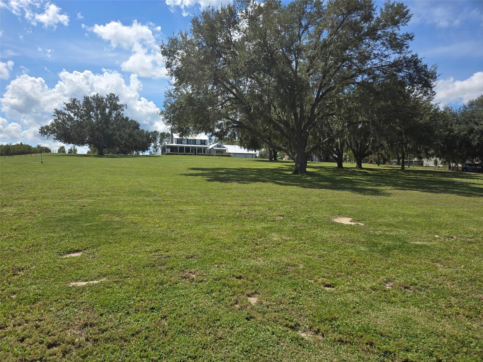 An unbelievable opportunity has become available in the quaint town of Clermont! If strolling or fitness is your hobby, this town has it all. A special place taking you back in time, while walking, running, and biking are available on the Clermont/West Orange Trail that goes right through the town. This special town is sprinkled with restaurants, merchandise boutiques, amazing lakefront dining and plenty of bakeries and ice cream stores to cure that sweet tooth. A local brewery is coming to town with special events while the mayor makes sure every holiday is celebrated, whether it’s decorated, has holiday music or fireworks!  While the town is nestled around the Clermont chain of lakes, you have easy access to major expressways and Themed Parks. This is Florida that meets new Florida for sure!!
Now get ready to visit your newer lakefront home 7956 Lake Nellie Road! A true country feel, as you travel to your little bit of paradise just waiting for your imagination.  With almost 5 acres of land, you can fulfill your dream of raising chickens or bringing your horse while still water skiing on your private Lake Nellie. Your dock is ready to add your floating docks to place your water toys!
As you drive to your impressive estate, expect to be impressed as your land sprawls over both sides of the road. As you pull in your long driveway, get ready for the magic of carefree living in your gently used 2019 custom home. Enjoy the breathtaking views as you stroll towards the front door and take note of your screened in front porch that possibly could become one of the many favorite features of the home.
March through the door and explore the breathtaking great room with beautiful wood floors. This amazing space includes a fireplace and windows to give you views of your entire property. The wraparound porches are breathtaking, while this space allows you to be creative in setting it up for your lifestyle. The room flows into your gourmet kitchen with an amazing, oversized island perfect for preparation and social events. A commercial Gas cooktop with separate double ovens will make your chef in the family extremely happy. The oversized pantry and utility area can double as an additional food prep area and kitchen planning center. You have a great view of the backyard from your kitchen to watch the family. As you stroll outside through the mudroom to join them, have comfort knowing it is fully fenced.
When you are ready to retire for the evening, your guests can stroll to their detached space with a private entry from the back. For you, pass through the great room to a parlor to catch up on some reading before retiring to the bedroom with a private lakeview patio. An impressive walk-in closet and resort style spa bathroom awaits with a soaking tub, double sinks, walk-in shower and private commode to complete the primary. The rest of the family can head upstairs to a bonus room perfect for gaming before heading to the two junior suites with walk-ins and private bathrooms.
 
There are too many upgrades to mention but, the entire home is encapsulated with foam insulation, Hardie plank siding, a 12KW Emergency generator and have an oversized 3 car garage for the toys and a workshop

This home has it all, so make your private appointment today while the opportunity still exists.