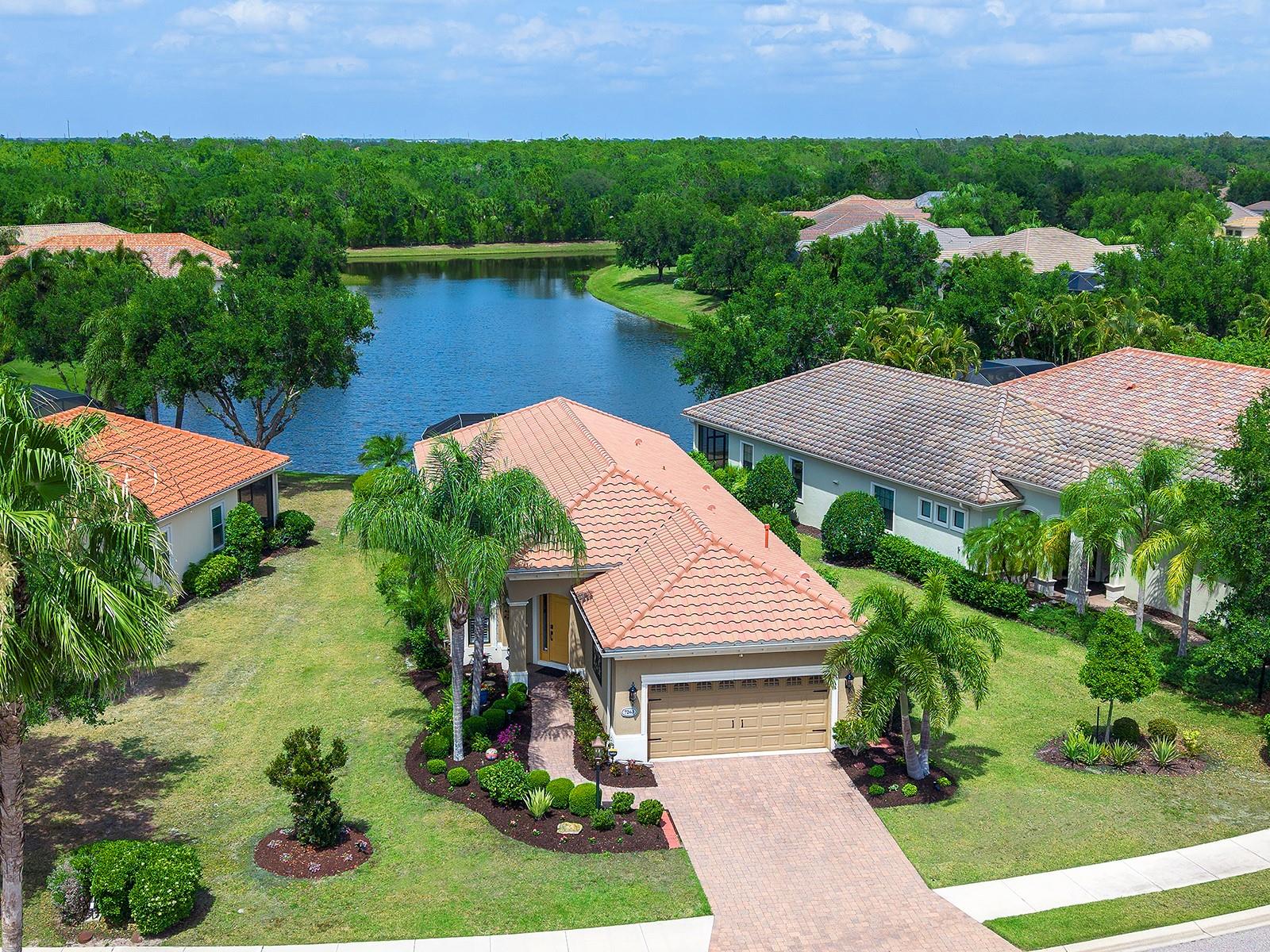 INCREDIBLE PRICE IMPROVEMENT! This charming lakeside home has been nicely renovated in the Belleisle enclave of Country Club East and is brimming with smart upgrades, chic design, and a functional floor plan.  Surrounded by lush landscaping with grounds maintenance included in your HOA dues, this home is a Florida oasis that’s perfect for a full time or part time residence in one of Lakewood Ranch’s most desirable neighborhoods.  It’s easy to enjoy the long lake views from the paver lanai which has been thoughtfully expanded for more entertaining space and highlighting the lake views through a panoramic screen enclosure.  In addition, there is a remote-controlled hurricane-rated screen that is not only great for storm protection, but also offers convenient shade during the afternoon.  Entertaining inside is a delight in the grand great room with tray ceiling.  The kitchen has been remodeled with a modern flair including refinished cabinetry, quartz counters with waterfall edge, counter-height bar seating, instant hot water and faucet at the sink, under and above cabinet lighting, and an upgraded pantry.  Savor morning coffee in the casual dinette with upgraded light fixture and delight in meals at the formal dining space.  The flexible den with double doors offers privacy for work or add a sleeper sofa or murphy bed for a third bedroom.  The primary suite shines with lake views, engineered hardwood flooring, and two walk-in closets outfitted with custom closet systems by Closets by Design.  The spa-like en-suite bath offers refinished cabinetry, quartz counters, private water closet, and walk-in shower.  Guests will find comfort in their own bedroom with engineered hardwood flooring and new ceiling fan, plus adjacent full bathroom with refinished cabinetry, quartz counters, and tub with shower combination featuring wall-to-wall tile.  The functional laundry room showcases a 2021 Samsung washer and dryer, and convenient utility sink and storage closet.  The two-car garage includes epoxy flooring, storage racks, and EV charger.  Peace of mind is secured with 2025 AC system, 2023 water heater, new rain gutters, solid-core interior doors, and security system.  Enjoy the country club lifestyle at the gated Country Club East with 3 community pools, fitness center, clubhouse, walking trails, social events and more. If you’re looking for additional amenities, membership to Lakewood Ranch Golf and Country Club is optional and available for access to 3 Clubhouses, 4 championship 18-hole golf courses, fitness center with pool, and tennis and pickleball courts.  Lakewood Ranch is the top multi-generational community in the country for 8 years in a row with plentiful shopping, dining, parks and nearby beaches.