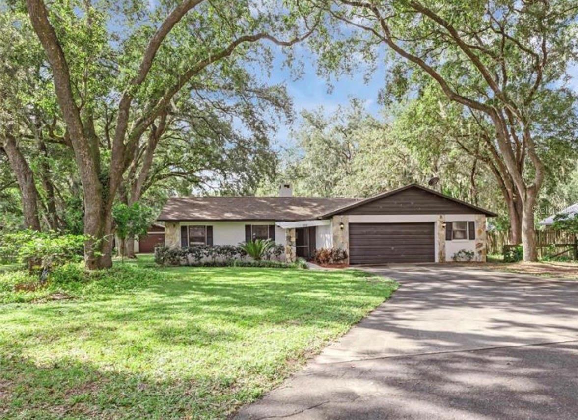 New roof! Check out this beautiful pool home listing, conveniently located Fruitland Park. This 3 bedroom, 2 bathroom pool home has so much to offer. When you walk in the front door, you are greeted by a large open concept living room with a large beautiful stone wood-burning fireplace. The living room is open to the dining area and the kitchen - which features newer appliances! There is a separate family room on the back of the home, that offers even more living space for entertaining or for a potential office or den area. There is a full air conditioned laundry room to the left of the garage and it runs the whole length of the garage. Hot water heater (2021). On over half an acre of land, this home boasts a workshop and screened in pool with a large deck and a newer pool pump (2024). There is also a separate screened enclosure off the back of the home. The entire yard is fenced and a new drain field was also put in a few years ago. Call today to schedule your showing.