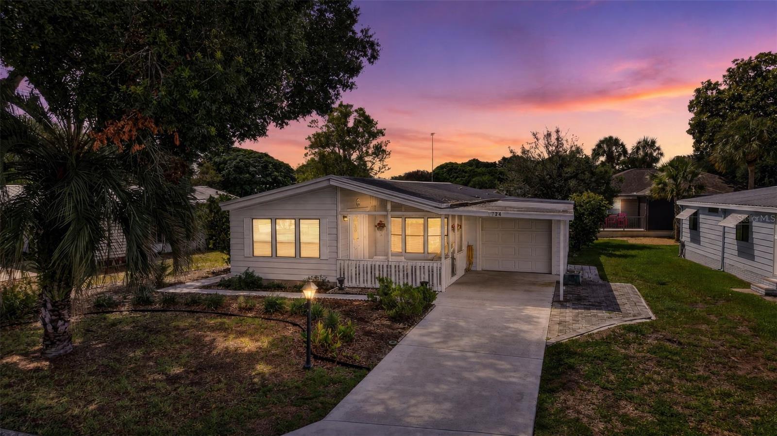 Discover the charm of one of the original neighborhoods in The Villages, where mature trees and established landscaping create a setting that's hard to find in the newer sections of the community. This well-maintained 2-bedroom, 2-bath home features the rare combination of an enclosed garage, covered carport, workshop, screened lanai, inviting front porch, air-conditioned sunroom, and an inside laundry room. Enjoy world-class golf, recreation centers, swimming pools, pickleball, dining, shopping, entertainment, and countless clubs and activities that make The Villages one of Florida's premier 55+ communities. Come experience the lifestyle you've been waiting for!