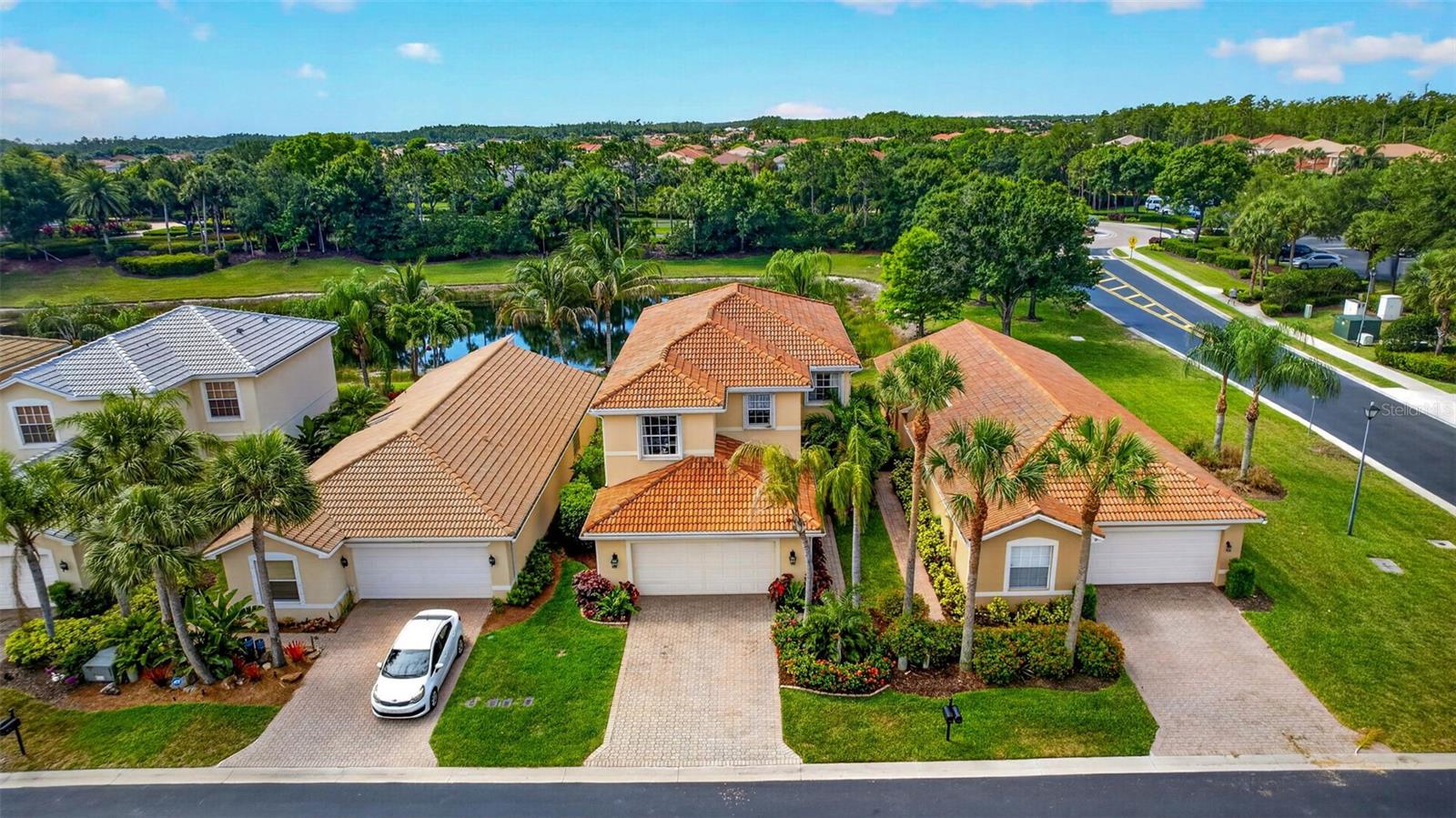Lakefront home in the gated community of Botanica Lakes, featuring 5 bedrooms and 3 bathrooms across 2,655 sq ft. Two-story concrete block construction with tile roof, 2-car attached garage, and shutters on all windows. Interior features include an open floor plan, HVAC 2019, coffered ceilings, built-in cabinets, dining in living and eat-in kitchen, pantry and full appliances, screened lanai with lake views and in-residence laundry with washer and dryer included. Primary bath features dual sinks with separate tub and shower. Tile and carpet flooring throughout. Community includes features such as lawn, pest control, 3 cable boxes, internet, clubhouse, pool, kids splash pad, pickleball, basketball court, fitness center, playground and gated community. Whether you're looking for a place to put down roots or a retreat to call your own, this home checks every box.