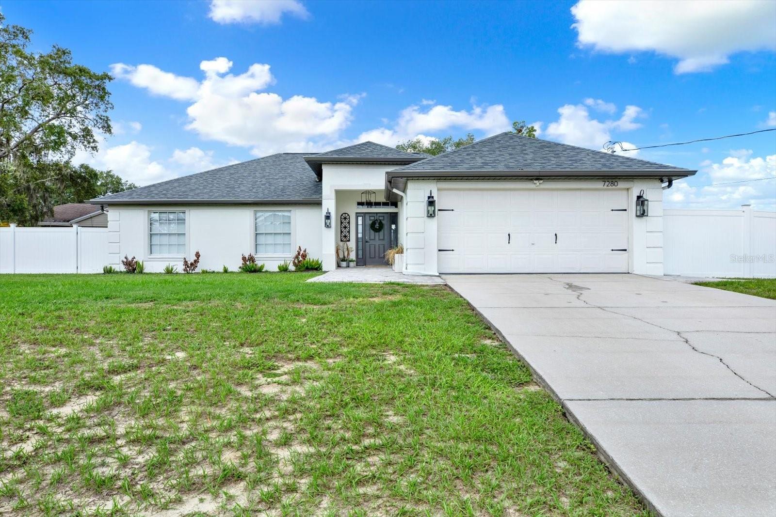 Completely renovated 4BR/2BA/2CG corner-lot home with NO HOA. No side neighbors, plus an extra-tall vinyl privacy fence wrapping the backyard for total seclusion. Step inside to soaring cathedral ceilings throughout the main living area, custom drapery, and designer roller shades. The stunning open-concept kitchen is built for entertaining. Every finish was thoughtfully chosen — this is not a builder-grade flip. Garage features a durable epoxy floor. Major systems fully updated: ROOF (2024), AC & Water Heater (2021), plus a generator hookup already in place. Outside is a true backyard retreat — pavers, fire pit, gazebo, and a brand-new playground on artificial turf, all completely private. Minutes to US-19 shopping, dining, and local beaches, with easy Veterans Expressway access to Tampa Bay. Schedule your showing today.