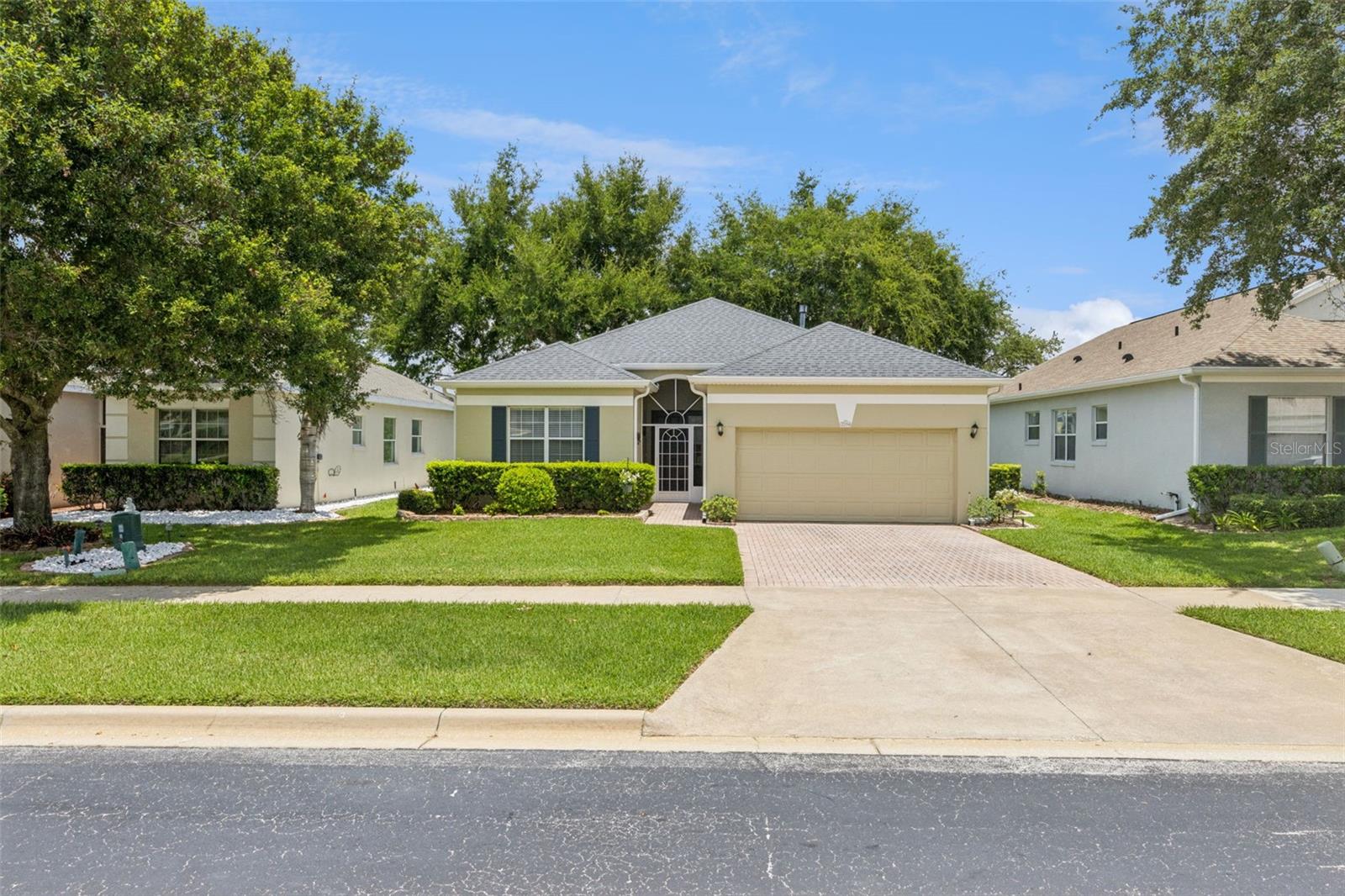 Gorgeous views from this golf-front home.  You will enjoy sitting on your screened lanai relaxing overlooking Clarence Lake as well.  The lanai is very large at 213 square feet.  Inside is spectacular too with upgraded kitchen with granite counters, stainless Whirlpool gas range, dishwasher, refrigerator along with a Samsung built-in microwave.  All appliances stay -- including the GE washer and dryer.  There is no wall-to-wall carpet in this home.  Roof  2015, AC 2016, and Water Heater 2019.  The 2 bathrooms in this home have upgraded vanities as well as granite counters.  The Primary Bedroom has an extremely large walk-in closet as well as views of the golf course and lake.  This home overlooks the 13th fairway of the Clermont National Golf course.  Some of the furnishings are available separately.  There is much more to this home. Summit Greens is a 55+ community with resort-style living that's gated, golf,  and many amenities including basic cable, all yard maintenance, 28,000 sq. ft clubhouse with an indoor/outdoor heated pool, clay tennis courts, and pickelball, Community is in the rolling hills of Clermont and 5 minutes from the Turnpike and in the heart of all types of shopping, restaurants and hospitals.