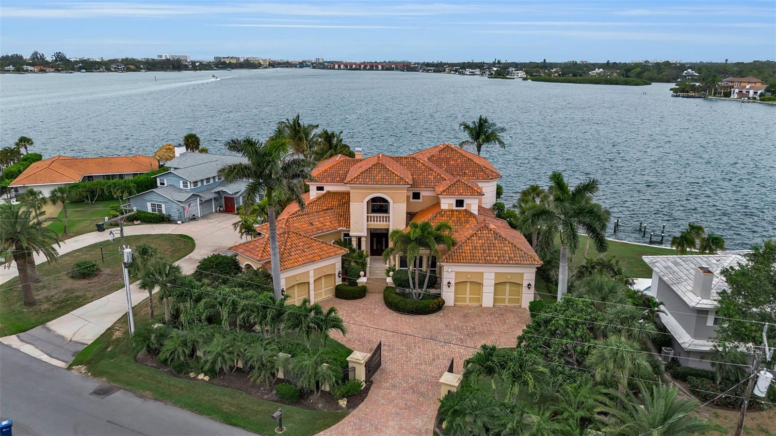 Perfectly positioned on approximately 130 feet of deep sailboat water, this exceptional waterfront estate offers an extraordinary opportunity to experience the very best of Sarasota’s luxury lifestyle.

Encompassing over 6,100 square feet, the residence was thoughtfully designed to balance grand-scale entertaining with comfortable everyday living. A dramatic two-story living room, sweeping staircase, extensive custom millwork, and walls of glass create a sense of timeless elegance while framing breathtaking water views throughout the home.


The gourmet kitchen serves as the heart of the residence, seamlessly connecting to multiple gathering spaces and opening effortlessly to the expansive waterfront terrace. Corner sliding glass doors dissolve the boundaries between indoors and out, revealing a resort-style infinity-edge pool, summer kitchen, covered entertaining areas, and sparkling bay views beyond.

The luxurious primary suite is a private waterfront retreat featuring a separate dressing room, generous dual closets, and serene water vistas. Additional guest suites provide exceptional comfort and privacy for family and visitors alike.

Designed for both recreation and relaxation, the home also features a private office/library, elevator access, media and game room with full bar, and a four-car split garage.

Outside, the lifestyle continues with a private dock, boat lift, fishing pier, and immediate access to Sarasota Bay. Whether enjoying sunset cruises, waterfront dining, or simply relaxing poolside while watching dolphins and boats pass by, every day feels like a vacation.

Rarely does a property combine this level of space, waterfront presence, boating access, and location. Just minutes from downtown Sarasota, St. Armands Circle, and the area’s renowned beaches, this is a home designed for those who expect the very best.