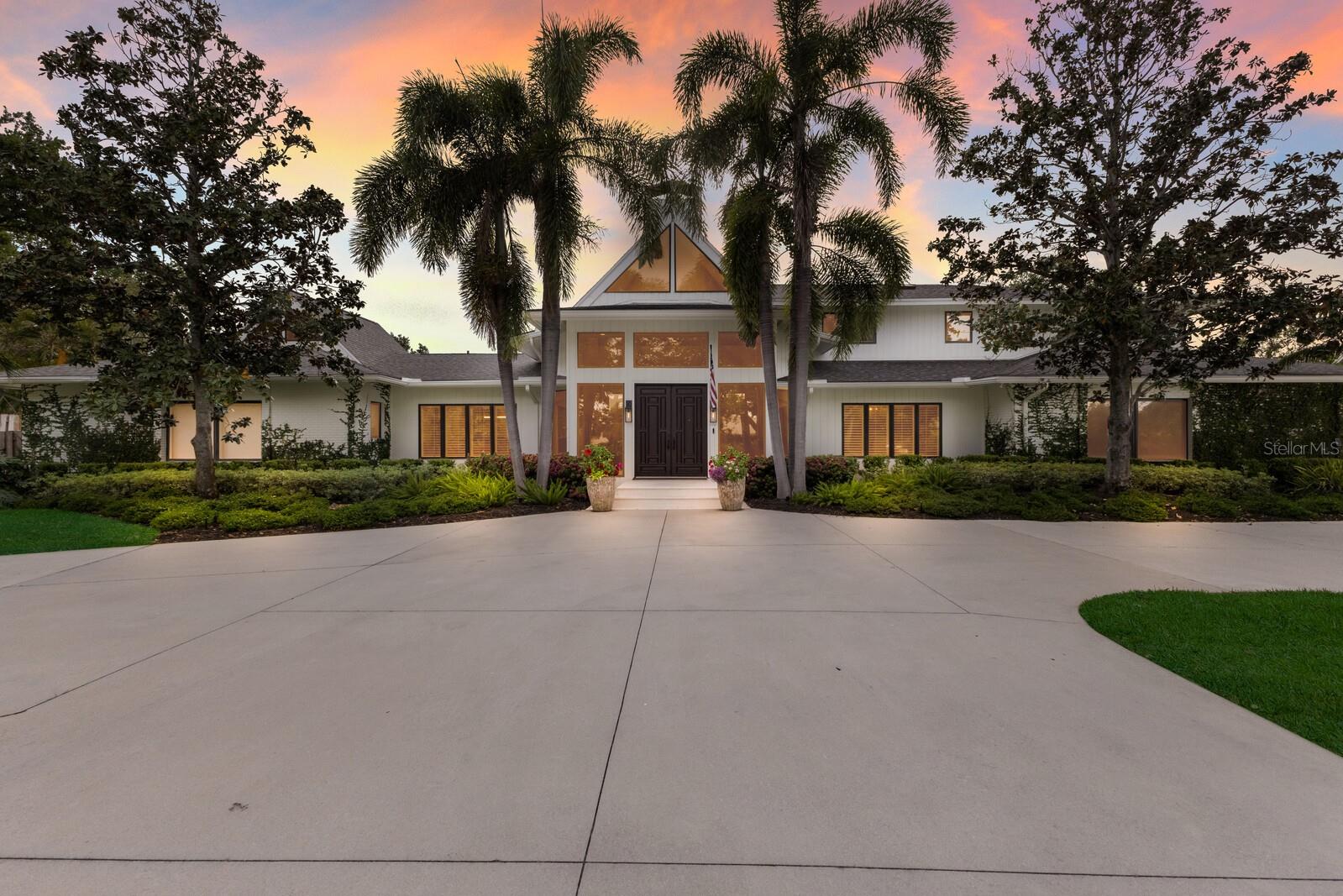 Welcome to 3709 Beneva Oaks Way, an extraordinary estate nestled within the gated enclave of Beneva Oaks, where timeless elegance meets modern luxury on a private, lushly landscaped one-acre sanctuary just minutes from Sarasota’s renowned beaches, shopping, and dining. Completely reimagined in 2021 by esteemed Luxury Home Builder, Vertical l Design+Build and award Winning Interior Design Firm, Trade Mark Interiors, this impeccably curated residence features comprehensive upgrades including all-new pool equipment and heating, whole-house re-plumbing and re-wiring, advanced HVAC ducting with automated controls, a ground-level I-joist floor system, designer lighting an automated landscape lighting, new flooring, alarm system, fresh sod and landscaping, two new septic systems, and a brand-new roof in 2024 for lasting peace of mind. Celebrated for its exceptional design, the home has been featured in Martha Stewart Living, House Beautiful, and Southern Living, with award-winning kitchen, living room, and primary bath recognized by Florida Design Magazine’s Seaglass Design Awards, SRQ Magazine’s Home of the Year, and Best Overall Renovation Honors. Grand double doors open to a breathtaking interior defined by soaring ceilings, walls of glass, and an open-concept layout designed for both refined entertaining and everyday comfort. The dramatic living room showcases exquisite designer lighting and a striking marble fireplace, while the chef’s kitchen is a true showpiece with top-tier Thermador appliances, six-burner gas cooktop, double wall ovens, convection microwave, Fisher & Paykel dishwasher drawers, Bosch dishwasher, dual farmhouse sinks, pot filler, ice maker, wine refrigerator, and an oversized island with bar seating that flows seamlessly to the outdoor living areas. An expansive game room with an old-world, five-star-hotel-inspired bar sets the stage for unforgettable evenings, complemented by a stunning dining room adorned with statement lighting and elegant Japanese-inspired wallcovering. The primary suite is a private retreat with a sitting area, direct pool and spa access, and a spa-inspired bath featuring a soaking tub, walk-in shower, dual vanities, custom cabinetry, and hand-selected antique marble and limestone flooring with radiant heat. Outdoors, the resort-style pool and expansive entertaining areas create a serene oasis for alfresco dining and relaxation, while four generous guest suites with walk-in closets and full bath access providing exceptional comfort. Completing the estate is an oversized three-car garage with workshop, abundant storage, and the ultimate man cave—making this remarkable residence a rare offering that embodies impeccable design, craftsmanship, and elevated living.