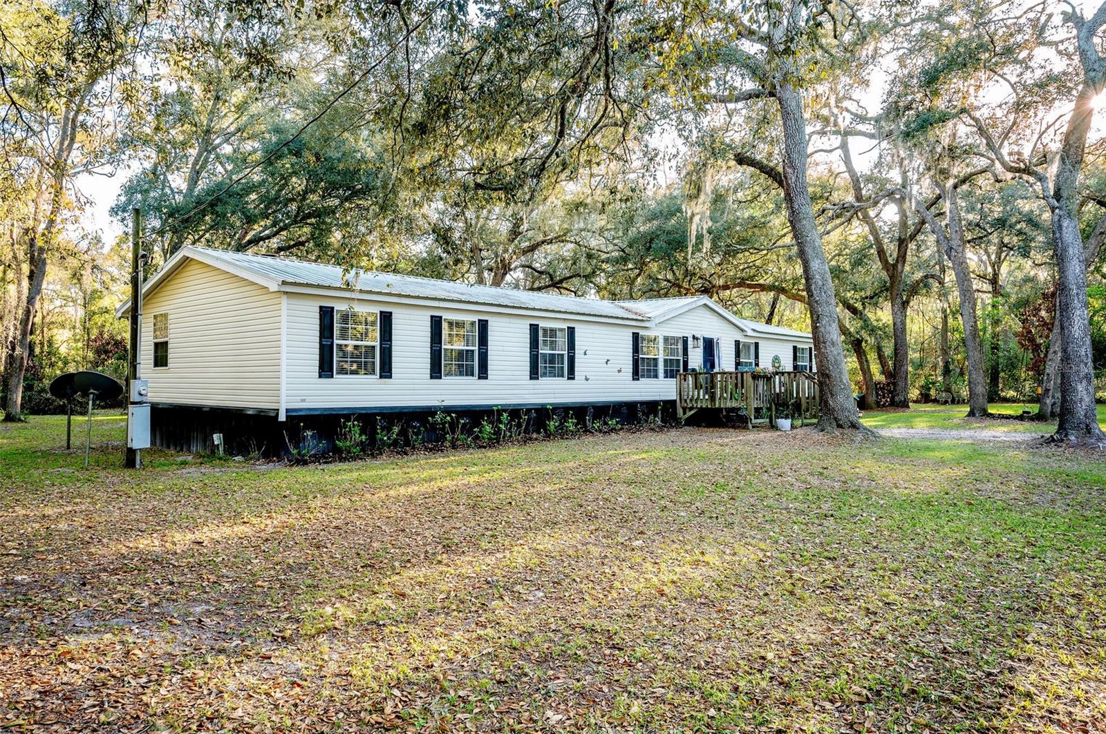 Welcome to your slice of North Florida paradise! This beautifully maintained 4-bedroom, 2-bath manufactured home in Trenton sits on an oversized 1.42-acre double lot, offering the perfect blend of space, comfort, and location. Inside, you’ll find both a spacious living room and a separate family room, ideal for entertaining or spreading out, along with beautifully UPDATED KITCHEN, updated flooring, new cabinets, countertops, and modern vanities throughout. All bedrooms feature generous closet space, while the primary suite boasts an additional living space that could be easily used as a home office, gym or nursery, as well as a large walk-in closet you’ll love. The home is topped with a durable metal roof and has been thoughtfully updated, making it truly move-in ready. Step outside and enjoy the peaceful surroundings, with plenty of room for outdoor living, gardening, or storing your toys. Nature lovers will appreciate being just 3 miles from Fanning Springs and within 15–20 minutes of other stunning springs like Hart Springs, Otter Springs, and Manatee Springs, perfect for swimming, kayaking, and soaking up Florida’s natural beauty. Plus, you’re just a short drive to Cedar Key for coastal charm and to University of Florida, one of the nation’s top public universities, known for its strong academics, vibrant campus life, and unbeatable school spirit. Whether you’re looking for a full-time residence, weekend getaway, or investment opportunity, this property checks all the boxes! Call to schedule your private showing. You don't want to miss this one!