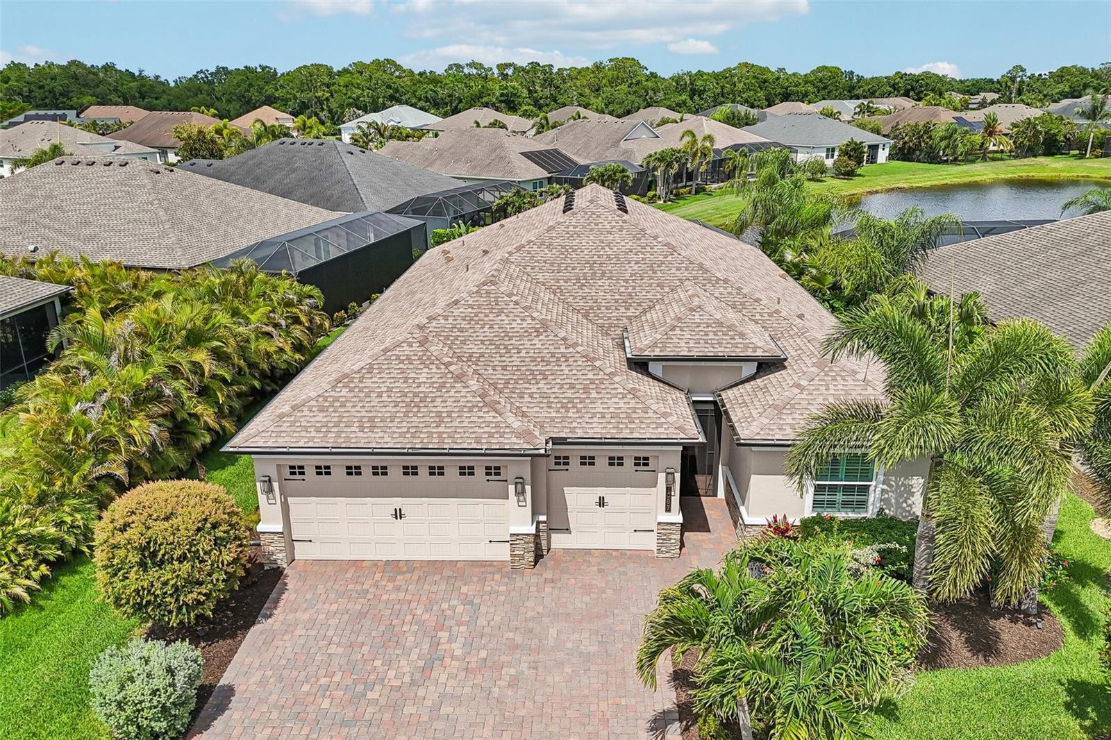 Welcome to this meticulously maintained and thoughtfully upgraded 2022 Sam Rodgers Captiva model in GreyHawk Landing. Offering 3 bedrooms plus a den, 2.5 baths, a 3-car garage, soaring ceilings, hurricane-rated impact glass, elegant finishes, and tranquil pond views, this coastal-inspired pool home creates an exceptional retreat.
Located in the newer section of the community with reclaimed water irrigation, this beautifully designed home features an inviting screened front entry, quality craftsmanship, privacy, and a light-filled open-concept floor plan designed for comfortable Florida living.
The expanded kitchen is designed for both everyday living and entertaining, featuring quartz countertops, a large center island, spacious pantry, decorative tile backsplash, gas cooktop, wall oven and microwave, stainless steel appliances, and an open flow into the great room and dining area.
Interior features include tile plank flooring throughout, plantation shutters, designer lighting, added recessed lighting, a remote-controlled rear slider shade, oversized tankless water heater, whole-house generator, water softener system, reverse osmosis drinking water system, insulated garage doors and ceiling, and an in-wall pest control system.
The spacious primary suite offers a relaxing retreat with peaceful views, a custom-designed walk-in closet by Closets by Design, and a beautifully appointed en-suite bath. Guest bedrooms are thoughtfully positioned for privacy and comfort, while the den provides flexible space for a home office, media room, or additional guest accommodations.
Large sliding glass doors fill the home with natural light and create a beautiful connection to the private outdoor living spaces.
The kitchen and living areas extend to the screened lanai featuring a saltwater pool with gas heater, outdoor kitchen, expansive covered entertaining area, professionally installed low-voltage lanai lighting, and professionally landscaped surroundings creating a private and relaxing outdoor retreat.
Additional upgrades include laundry room cabinetry, glass shower enclosure in the guest bath, and granite vanity in the powder bath.
A rare opportunity to own a newer Captiva model in GreyHawk Landing. Furniture available as an optional separate purchase.
Greyhawk Landing is a gated, amenity-rich community offering two resort-style pools, a fitness center, tennis, pickleball and basketball courts, scenic nature trails, a fishing pier, and 24-hour security. Ideally located near top-rated schools, I-75, shopping, dining, and Gulf Coast beaches. Don’t miss this opportunity to enjoy Florida living at its finest!