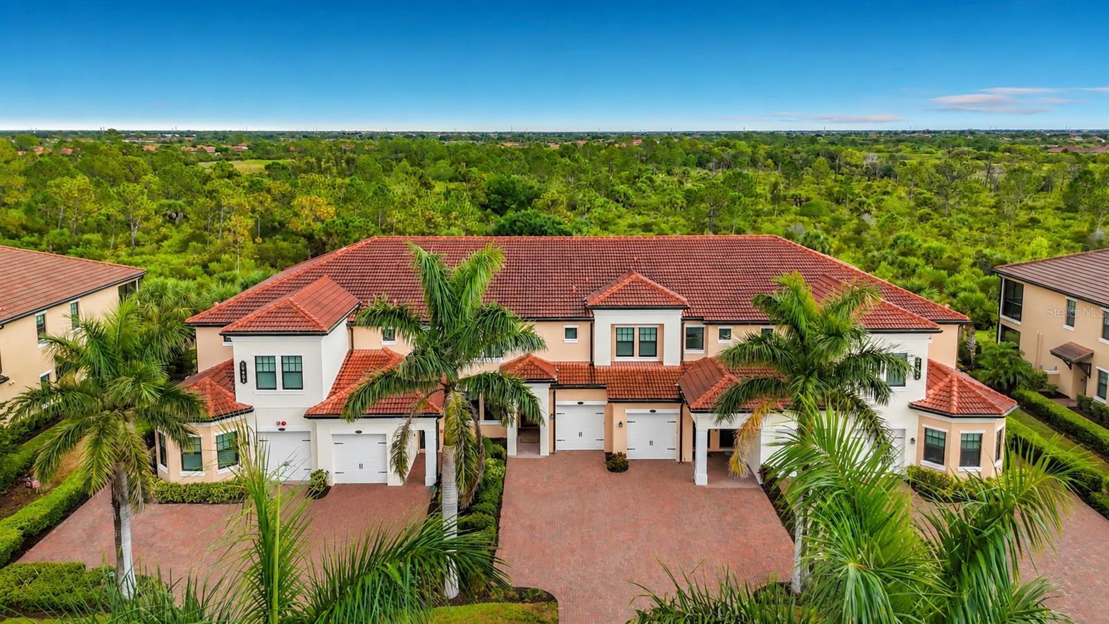 Quiet Luxury, Exceptionally Curated. Welcome to a home where elevated design and impeccable craftsmanship converge. Tucked away on a quiet cul-de-sac street within the sought-after community of Sarasota National, this extraordinary ground-floor condominium has been meticulously reimagined with an uncompromising commitment to quality, creating a home that is as timeless as it is distinctive. Offering two bedrooms, two bathrooms, and a one-car garage, the open-concept floor plan is enhanced by volume ceilings, crown molding throughout, and an abundance of natural light. At the heart of the home is the completely redesigned chef's kitchen - a true masterpiece. Rich porcelain countertops cascade into a dramatic waterfall island with a matching full-height backsplash, creating a striking focal point for everyday living and entertaining alike. A composite sink, Samsung induction range, slide-out cabinet drawers, and soft-close doors and drawers complete this luxurious yet functional space. The main living area has been elevated with a custom-built media wall featuring an elegant LED electric fireplace and shelf accent lighting, providing warmth, architectural interest, and a polished centerpiece. Throughout the main living areas, you'll find Robb & Stuckey "Duchateau" engineered hardwood flooring complemented by 5-inch baseboards, exemplifying timeless beauty, while the California Closets-designed primary walk-in closet maximizes both organization and style. The primary suite continues the home's contemporary aesthetic with luxurious micro-cement flooring that creates a clean, seamless ambiance. The primary en suite bathroom features a dual-sink vanity with quartz countertops and a spacious walk-in shower with a sleek, frameless glass door. The guest bathroom is equally impressive, showcasing an elegant micro-cement finish throughout the floor, shower walls, and built-in shelves. It is complemented by an Olive & David light fixture, a glass tub enclosure door, and an integrated granite sink that evokes the feel of a boutique luxury hotel. Beyond the interior, the home's peaceful preserve view provides a private backdrop for ideal Florida outdoor living. The screened lanai is finished with travertine flooring, creating the perfect place to enjoy the tranquil natural surroundings. Practical luxuries have not been overlooked. The spacious laundry room has been thoughtfully enhanced with additional cabinetry above the washer and dryer, along with an oversized storage closet that provides exceptional organization. Impact windows and slider provide peace of mind, complemented by the home's desirable Flood Zone 'X' location. In the garage you'll discover an electric panel surge protector, insulated garage door, and an EV charger which adds modern convenience. Every inch of this residence reflects thoughtful design, understated elegance, and exceptional attention to detail. Located within the amenity-rich, gated community of Sarasota National, residents enjoy an exceptional lifestyle featuring a resort-style pool, state-of-the-art fitness center, pickleball and tennis courts, tiki bar & dining, numerous social activities, dog park, and miles of scenic walking and biking trails - all just minutes from the Gulf beaches, Downtown Venice, Wellen Park, shopping, dining, and everyday conveniences. This is a rare opportunity to own a truly one-of-a-kind residence where luxury is defined by thoughtful design, timeless materials, and uncompromising quality.