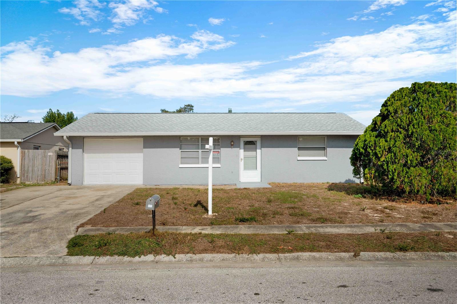 Welcome home! This delightful two bedrooms and one full bathroom home is centrally located and minutes away from Downtown New Port Richey. This home offers privacy with a spacious backyard that is fenced and surrounded by trees plenty of room to play in a great backyard. The kitchen is light and open, newly painted. No HOA. AC is just 3 years old. Brand new roof, November 2023. This home is ready for you to start making new memories! Affordable and ready for first time homebuyers, investors, or second home. WOW, under $200,000!