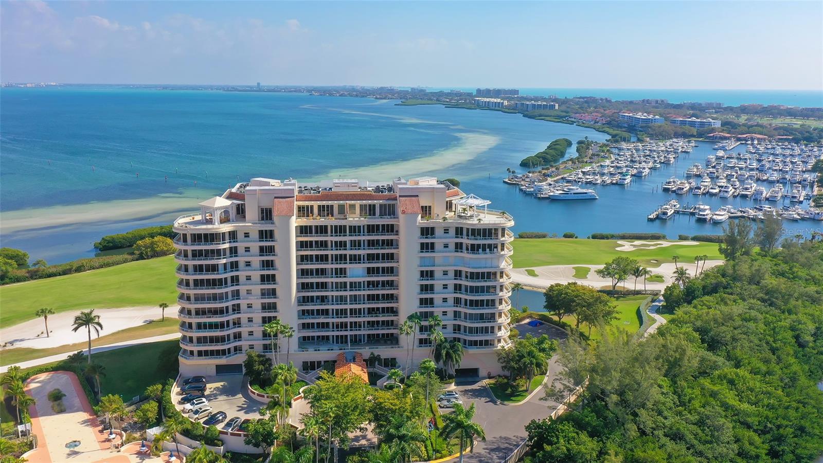 One or more photo(s) has been virtually staged. Perched just one floor below the penthouse in the sought-after Grand Bay IV community on Longboat Key, this 2,550-sq.-ft. Cayman floor plan offers an exceptional opportunity to enjoy the Grand Bay lifestyle immediately—while still allowing a future owner to complete their personal renovation plans once the building’s elevator modernization is finished. The furniture rental will extend for up to one year, giving the buyer time to enjoy the residence while preparing for future customization or construction. With ideal north–south exposure, this residence captures breathtaking sunrises over Sarasota Bay and stunning Gulf sunsets from two expansive terraces. Walls of glass and abundant natural light enhance the open-concept layout, which includes 2 bedrooms, 2.5 baths, and a den that can easily be reconfigured to include a walk-in closet for a 3rd bedroom. The primary suite opens directly to the Bayfront terrace, the second bedroom offers an en-suite bath and private Gulf-view balcony, and the den, kitchen, and third bedroom share access to a second terrace for effortless indoor-outdoor living. Two prime, side-by-side parking spaces on the upper main level sit conveniently next to the elevator, leading to a private elevator foyer. Residents of Grand Bay enjoy world-class amenities including 24-hour security, a clubhouse with library and game room, fitness center, tennis and pickleball courts, two heated pools and a spa, and deeded access to the exclusive Bay Isles Beach Club.