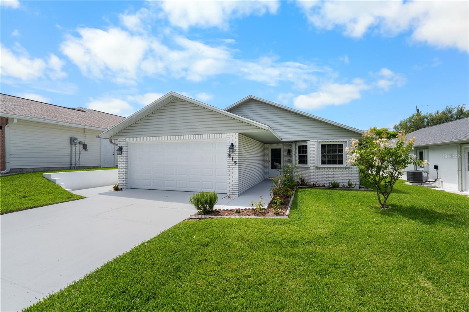 Virtually Staged. Just steps from the beach and only blocks from convenient no-drive beach access at 27th Avenue, this meticulously maintained beachside home is ideally located in one of the most desirable areas of New Smyrna Beach. Lovingly cared for by the same owner for the past 37 years, this move-in-ready residence offers 3 bedrooms, 2 bathrooms, a versatile den, and 1,607 square feet of heated and cooled living space on a generous 50' x 150' lot. Pride of ownership is evident throughout, with numerous recent upgrades providing peace of mind for years to come, including a new roof (2022), A/C system (2024), hot water heater (2026), beautifully remodeled kitchen (2025), updated tile flooring (2023), newer vinyl flooring in the living room, and fresh interior paint (2025). The home also features all new wind-rated windows installed in 2016, an updated electrical panel with generator plug, central vacuum system, and a current termite bond through January 2027. The thoughtfully designed floor plan includes a spacious primary suite with a walk-in closet and an air-conditioned den that was remodeled by the owner, adding approximately 204 square feet of additional living space. The washer and dryer are included, making this home truly move-in ready. A spacious two-car garage provides ample room for vehicles, beach toys, and additional storage. Outside, enjoy the spacious backyard featuring mature fig and rain trees, a beautiful paver patio installed approximately six years ago, and a sprinkler system supplied by city water. A rare rear alleyway behind the property provides unique access behind the home and offers flexibility and convenience not commonly found in beachside neighborhoods. Park the car and take the golf cart to nearby grocery stores, pharmacies, restaurants, Flagler Avenue, and Historic Canal Street. Enjoy the relaxed coastal lifestyle that has made New Smyrna Beach one of Florida's most sought-after beach towns. Whether you're looking for a primary residence, vacation home, or investment property, this well-maintained beachside gem offers the perfect combination of location, updates, and timeless Florida charm.