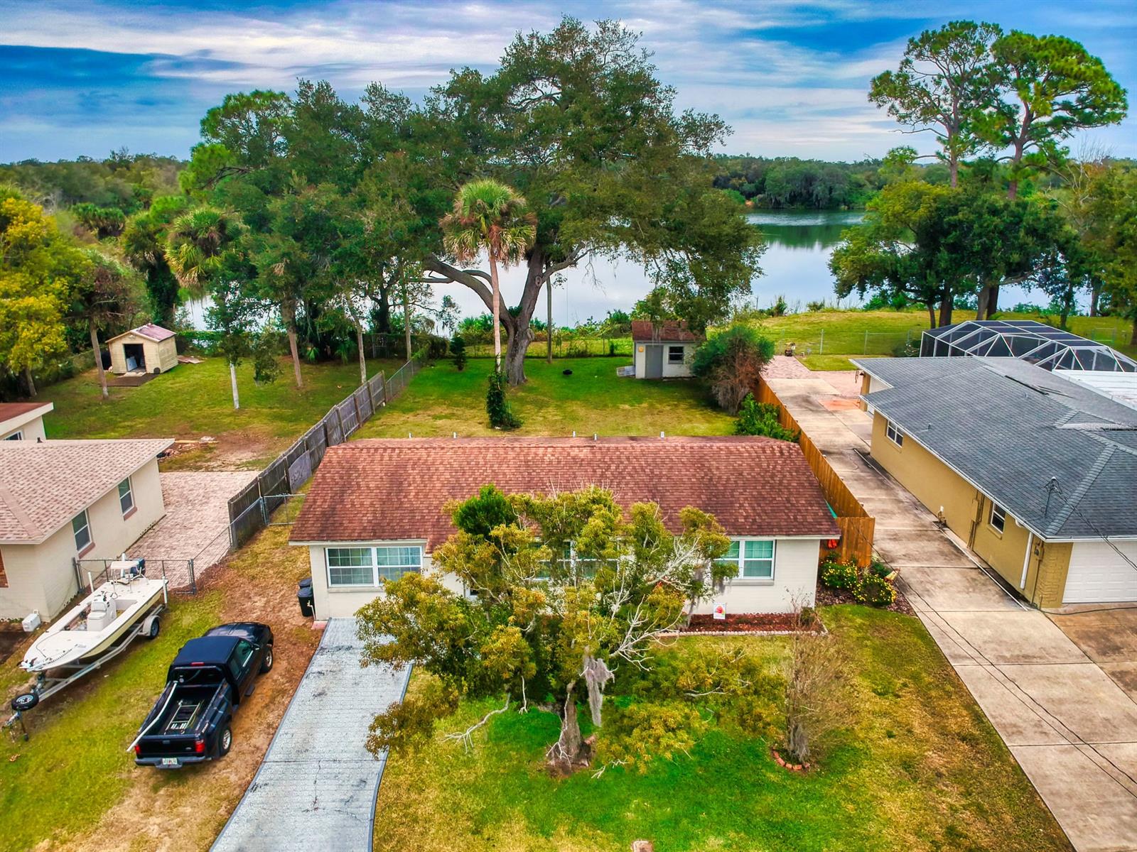 NATURAL BEAUTY, PRIVACY. This sweet home with artisan updates is a MUST SEE. The serene backyard abuts a small lake perfect for fishing or paddling. Bonus room can be bedroom (with closet), den or office. Inside laundry, storage shed/workshop (with power), plenty of room for boat or RV, pool. A/C 2014. Roof passed Sept 2020 wind mitigation. Virtual tour available! ;Water: City