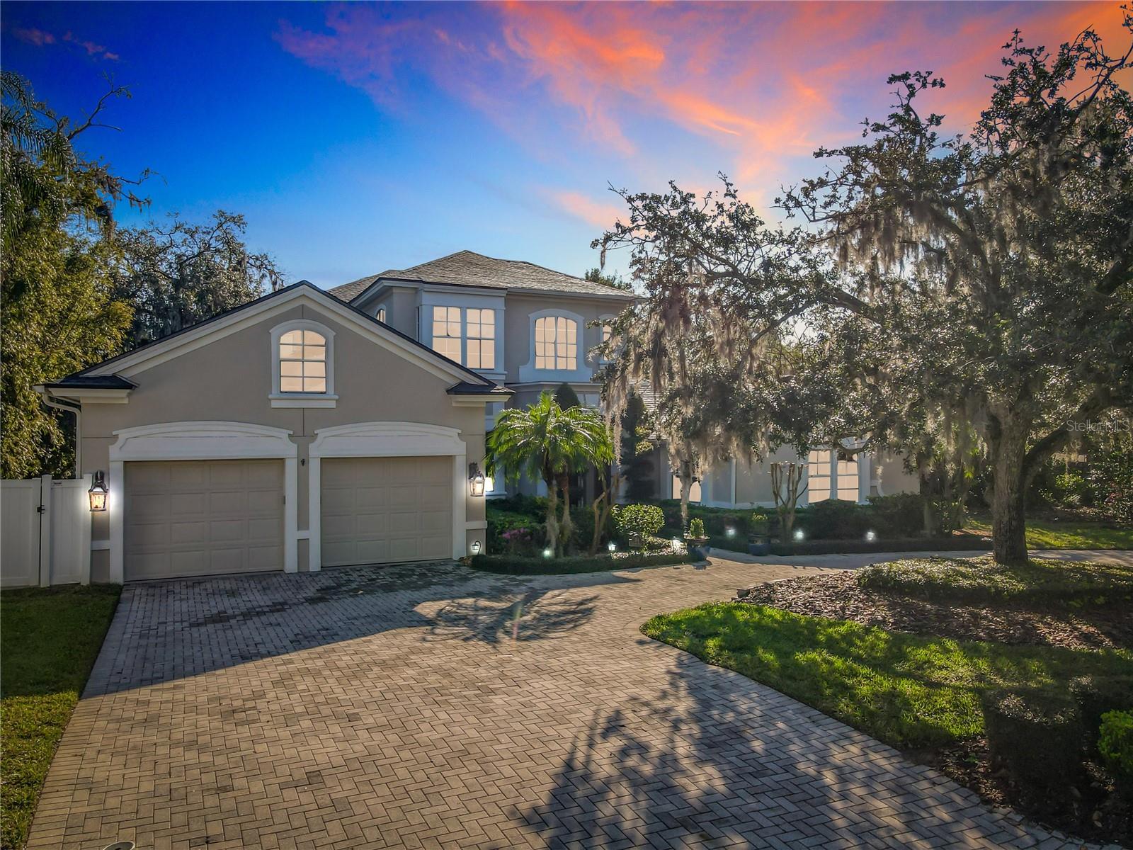Experience modern elegance in this stunning Lake Sylvan estate with breathtaking lake views and seamless indoor-outdoor living. The open-concept design features a gourmet kitchen (renovated 2023) with quartzite countertops, a wet bar, and luxe appliances. French doors, a custom gas fireplace, and designer lighting add refined charm to the living room. Step outside to nearly 1500 sqft of additional living space on the lake featuring a heated pool, spa, covered patio with gas fireplace, summer kitchen and lakeside firepit. With three bedrooms and a versatile office (easily a fourth), this home adapts to your needs. The first-floor primary suite opens to the pool, while an upstairs primary suite has dual custom closets, a spa-like bath, and a private flex space. Upgrades include a new roof with gutters and gutter guards (2022), new water heaters (2023), interior paint (2021) exterior paint (2023), water filtration, system, dual propane tanks, security system, plantation shutters, and three AC units. The above garage attic is accessible by staircase and can easily be enclosed to make a 5th bedroom, game room or flex space. This lakefront sanctuary offers privacy, sophistication, and modern convenience plus is located just minutes from Park Avenue's charming shops and restaurants. Don’t miss the opportunity to make this lake front home yours. Schedule your private showing today!