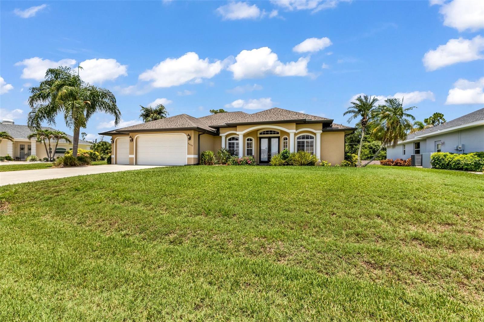 Welcome to 2430 Pebble Creek Place—a beautifully maintained heated pool home located in a desirable deed-restricted, gated community with a low HOA fee of just $230 quarterly. Offering 3 bedrooms, 2 bathrooms, a 3-car garage, and 2,165 square feet of living space, this exceptional home, built in 2004, is lovingly cared for and move-in ready, just waiting for its new owners.  From the moment you arrive, you'll be impressed by the inviting covered front porch and impressive double-door entry. Inside, the spacious foyer welcomes you with soaring ceilings and an open, light-filled floor plan designed for both comfortable everyday living and effortless entertaining.  The guest wing is privately situated to the right of the foyer and features two oversized bedrooms. Bedroom three offers sliding glass doors leading directly to the lanai, making it perfect for guests, a home office, or hobby room. The guest bathroom includes a linen closet and convenient direct access to the pool.  The heart of the home features a spacious living room, formal dining room, and an open kitchen with a breakfast bar, pantry with pull outs and a cozy dinette overlooking the pool through a beautiful aquarium window. The layout creates the perfect gathering space for family and friends while bringing the outdoors in.  The private primary suite is a true retreat with sliding glass doors opening to the lanai. The luxurious ensuite bathroom features two separate vanities, two walk-in closets, a deep soaking tub, a walk-in shower, and a private water closet with a pocket door for added privacy.  The indoor laundry room is well-equipped with a utility sink, built-in cabinetry, and a full-size washer and dryer.  Step outside to your own Florida oasis. The expansive covered lanai overlooks the heated pool with a spill way feature providing the perfect setting for relaxing or entertaining year-round. A dedicated pool storage closet adds extra convenience, while the spacious 3-car garage offers plenty of room for vehicles, tools, and recreational toys. 
This exceptional home sits on an oversized lot with 11,811 sq. ft. with quality updates, spacious living, and outstanding outdoor space in one of the area's most desirable gated communities. Close to golf, medical, shopping, beaches and just a short drive to SunSeeker Resort, Fisherman's Village and the Punta Gorda Airport where Allegiant offers 48 nonstop flights with cities across the U.S.  Schedule your private showing today—this is one you truly don't want to miss!  This home has been meticulously maintained with numerous major updates, including: Roof (2023) Water Heater (2024) A/C (2020) Pool resurfaced (2021) Pool heater (2017) Pool cage (2016) Manibloc plumbing system and Security system, Septic inspected and certified (02/2026)