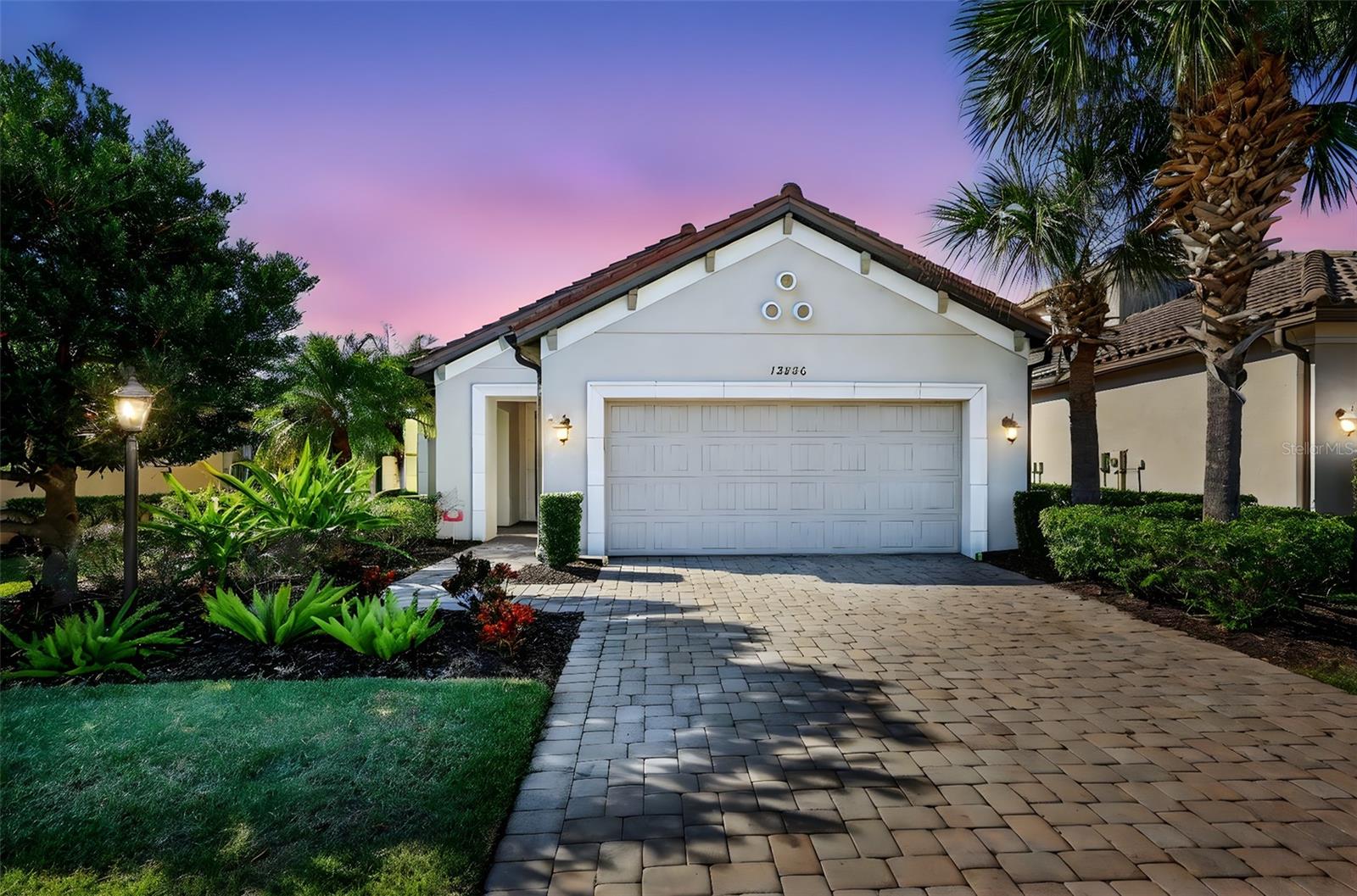 Virtually Staged. **Best Value in the Community. Significant Price reduction**. Welcome to this stunning, sun-drenched home in the highly sought-after Esplanade Golf & Country Club at Lakewood Ranch, where resort-style luxury meets low-maintenance living—and there are NO mandatory golf dues! This beautifully updated residence features 2 spacious ensuite bedrooms, a stylish half bath, and a versatile flex space ideal for a home office, library, or den. Perfectly situated just a short walk to the vibrant Amenity Center, this home combines comfort, convenience, and elegance. Step inside to find an open and airy layout filled with natural light, enhanced by wood-look luxury vinyl flooring and fresh, neutral tones throughout. In 2024, plush carpet was added to both bedrooms and the flex room, adding warmth and comfort. The chef-inspired kitchen was completely transformed in 2025 with gorgeous professionally installed cabinetry, sparkling granite countertops, an oversized under-mount granite sink, sleek new faucet, stainless steel microwave, eye-catching backsplash, and a generously sized center island—perfect for entertaining. The serene primary suite offers a spa-like retreat with a large walk-in closet, dual vanities, upgraded lighting, and designer touches. Additional features include freshly painted exterior (2021), accordion hurricane shutters (2021), and enhanced tropical landscaping for added curb appeal. Set within a lushly landscaped, gated community, residents enjoy access to world-class amenities including resort pools, a full-service fitness center, tennis and pickleball courts, spa, on-site dining, walking trails, and more. With a pay-to-play golf model, you can enjoy the lifestyle without the dues. Don’t miss the chance to make this exceptionally upgraded, move-in ready home your own!