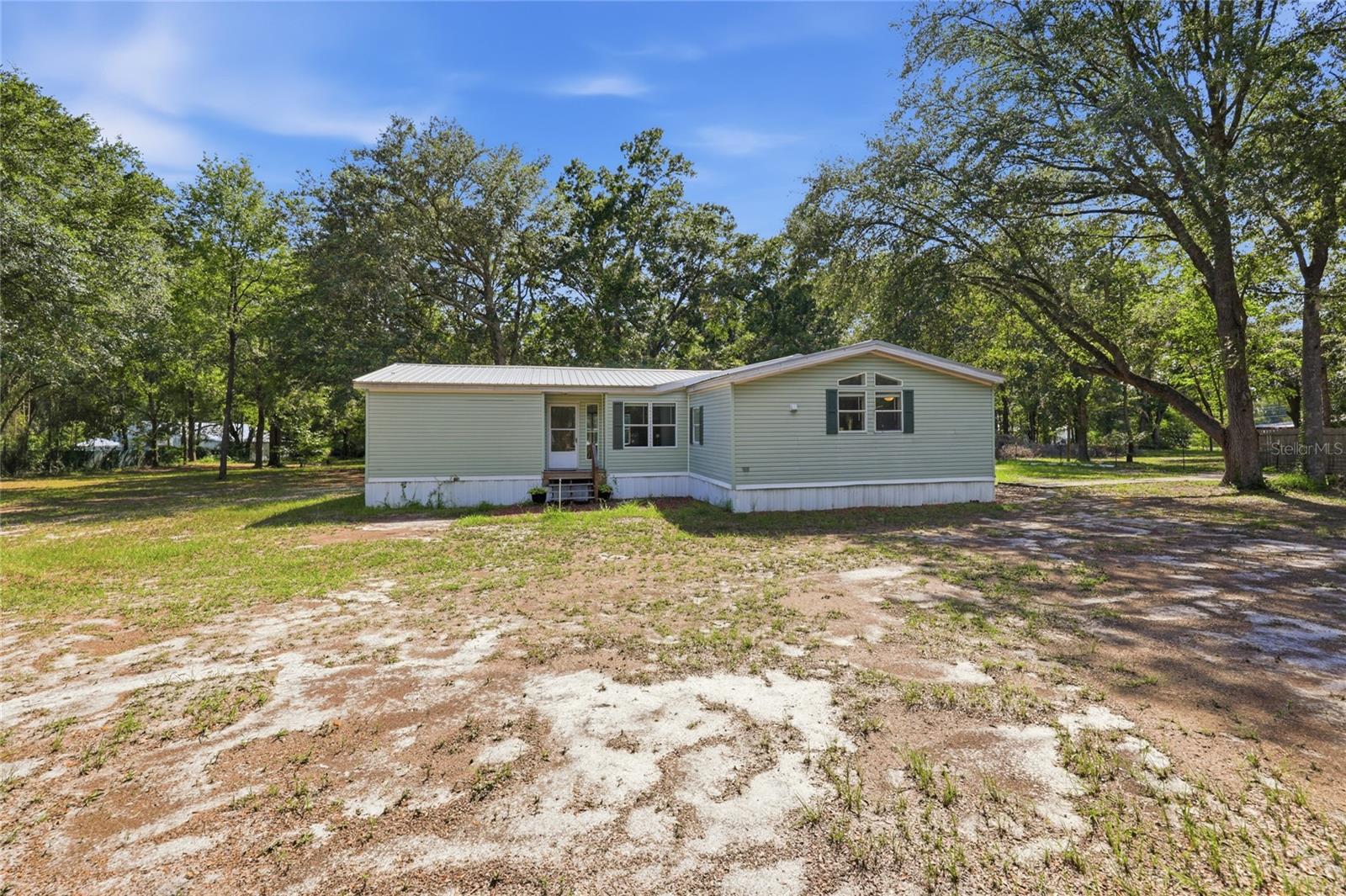 Welcome to this well-maintained 3-bedroom, 2-bathroom home offering 1,974 heated square feet on a peaceful 2.5-acre homesite. Designed with a desirable split-bedroom floor plan, this home provides both functionality and privacy. The spacious kitchen features stainless steel appliances, ample cabinetry, and generous counter space, opening to the main living areas for easy everyday living and entertaining. The living room is anchored by a cozy fireplace, creating a warm and inviting atmosphere. Luxury vinyl plank flooring extends throughout the main living areas, while the bedrooms are finished with comfortable carpet.

Enjoy the serenity of country living with plenty of room to relax, garden, or enjoy the outdoors, all while remaining conveniently located just 10 minutes from downtown Lake City and approximately 45 minutes from Gainesville. If you’re looking for privacy, space, and modern comfort with easy access to shopping, dining, and everyday amenities, this property is a must-see.
