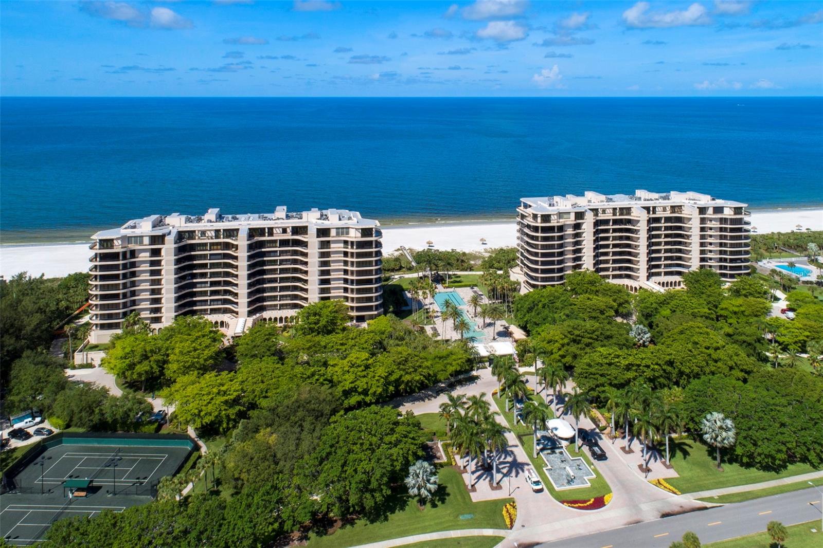 Introducing one of the most exclusive penthouses ever to come to market at L’Ambiance at Longboat Key Club. A rare chance to own a sky-high sanctuary in one of the most prestigious beachfront communities. Set against a backdrop of panoramic views stretching from the Gulf of Mexico to Sarasota Bay and the downtown skyline, this residence redefines coastal luxury. Spanning nearly 5,000 square feet, this move-in ready, impeccably maintained home is as functional as it is breathtaking, with a flexible 5-bedroom layout designed to comfortably accommodate large families or multiple guests. Whether you're hosting holidays, entertaining friends, or simply spreading out in style, this remarkable property delivers space, privacy, and elegance in equal measure. Step inside to discover soaring 13-foot ceilings, dramatic floor-to-ceiling windows, and multiple skylights that flood the home with natural light and amplify the spectacular, unobstructed views. Two expansive 75-foot terraces, one facing east, one west, offering private outdoor living with no neighboring buildings in sight, ideal for morning coffee, sunset dinners, or simply taking in the coastal breeze. The floorplan is both impressive and inviting, featuring a generous great room, formal dining area, office, bonus room and a spacious eat-in kitchen. The wet bar and great room area are perfect for relaxed evenings or lively gatherings, all set against the backdrop of sea and sky. The primary suite is a true retreat, featuring an en-suite bath, walk-in closet, and a nook perfect for your Peloton. Four additional bedrooms offer plenty of flexibility for guest suites. Additional perks include two prime garage parking spaces, an oversized climate-controlled storage room, and a private wine locker, ensuring effortless, secure living L’Ambiance offers true resort-style amenities: 24-hour security, concierge service, elevator access to your private foyer, guest suites, a heated lap pool and spa, Har-Tru tennis courts, a clubhouse with fitness center and sauna, and direct beach access. All of this, tucked behind the gates of the Longboat Key Club and just minutes from St. Armands Circle and the cultural epicenter of downtown Sarasota. A property of this scale, quality, and location is a rare find. A remarkable opportunity to step into elevated beachfront living, today.