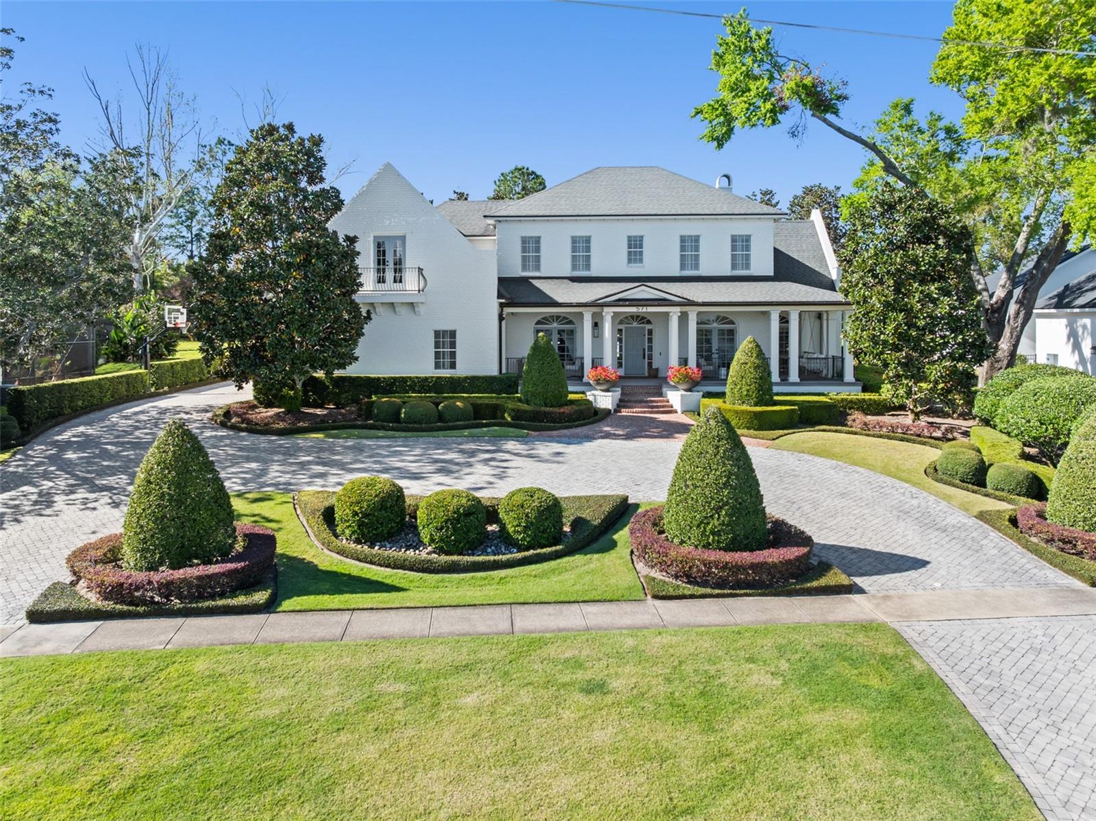 Welcome to this charming stately lakefront estate, a true gem straight from the pages of Southern Living—just minutes from Winter Park and the finest dining in Maitland, all on the serene shores of Lake Sybelia. From the moment you arrive, the large, inviting porch with it's charming swing beckons you into a home flooded with natural light and warm wood floors and a thoughtfully designed layout.

The heart of this home is the expansive kitchen, seamlessly flowing into the family room and offering French doors that lead to a picturesque backyard. The downstairs primary suite provides a luxurious retreat, featuring large walk-in closets and a beautifully remodeled bathroom with a soaking tub and dual vanities.

A private guest suite is conveniently located off the family room, offering its own entrance and separation from the rest of the home. Upstairs, you'll discover three generously-sized secondary bedrooms, a dedicated theater room, a private study, and a spacious bonus room complete with custom built-ins—perfect for play, work, or relaxation.  Move right in as this home has not only been freshly repainted but all bathrooms have been remodeled and refreshed. 

Step outside to your personal private oasis, with no rear neighbors, where a newly remodeled pool with a sun shelf, stunning decking, and fire bowls set the perfect ambiance for both relaxation and entertaining. The lush side yard enhances the home's charm, while the boat dock provides the perfect spot to watch breathtaking sunsets or enjoy water sports on Lake Sybelia.

This exceptional property offers the perfect blend of comfort, style, and lakeside living. Don’t miss the opportunity to make it your own!