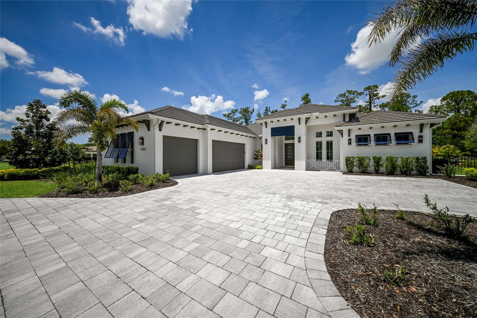 Positioned on over half an acre in the sought-after gated community of The Concession, this modern and stylish residence built in 2023 encompasses 3,460 square feet of generously proportioned one-story open living featuring an expansive outdoors with over 1,950 square feet of screened lanai boasting abundant under cover spaces, soaring ceilings, travertine pavers, full summer kitchen, fire table, PebbleTec heated pool/spa with sun shelf, panoramic clearview screen, all amidst a privately fenced preserve setting. 

Ten foot disappearing impact glass walls seamlessly connect the outdoor living spaces to the great room, kitchen and dining area with sumptuous luxury plank vinyl floors, stunning beam-accentuated volume ceilings, and a recently redesigned accent wall with floating shelves and fireplace. 

Meanwhile chefs will delight in the oversized kitchen adorned with wood cabinetry, quartz counters, two pantries, farmhouse sink, high performance appliances., double ovens, microwave drawer, newly designed hood, and a show-stopper wet bar with newly enhanced accent wall, shelving, new ice maker, beverage fridge, wine fridge and sink.  An impressive club room directly off lanai via disappearing cornerless glass walls beckons for entertaining or spill over guests, meanwhile the extra bonus room tucked behind pocket door is an ideal exercise room or secondary office. 

Serenity awaits in the owner’s quarters positioned on a private wing, offering large scale windows overlooking the preserve, direct lanai access, cozy sitting area, two customized walk-in closets, built in 3-way mirror, and a luxuriously appointed bath with two separate vanity stations with new mirrors centered by an oversized shower with floor-to-ceiling tile, dual shower heads, two benches and lit niches.  Two additional en suite guest rooms, each on separate wings of the home are generous in size, each with walk-in closets and their own private full baths. 

The residence also offers an ideal office just off the great room with built-in cabinetry, desk and shelving and a smartly positioned half bath off the bonus room and lanai.

Other notable highlights of this 5,328 total square foot stylish residence an stunning laundry room with cabinetry, sink, and even built-in doggy shower, a whole-home GENERATOR, all IMPACT windows, doors and sliders, new light fixtures, tankless water heater, recently added whole-home water filtration system, motorized window treatments,  a drop-zone mudroom area adorned with new wallpaper, prewiring with CAT6 cables and access points, camera security surveillance, sound system, large circular pavered driveway, air-conditioned “Florida basement,” and side load 3-car garage with electric car charger and air-conditioned wall unit. 

Elevated living near dining, shopping, polo, and the events in the vibrant Lakewood Ranch, Waterside Place, and UTC area, nearby to the enriching culture and beaches of Sarasota, this captivating residence proudly delivers on all fronts within this exclusive gated community renowned for its striking oak hammocks, pines and large lakes, and of course, for its championship golf course having hosted prestigious PGA Tour events including the 2021 World Golf Championships and the 2023 World Champions Cup, and most recently welcomed the Senior PGA Championship in April 2026.