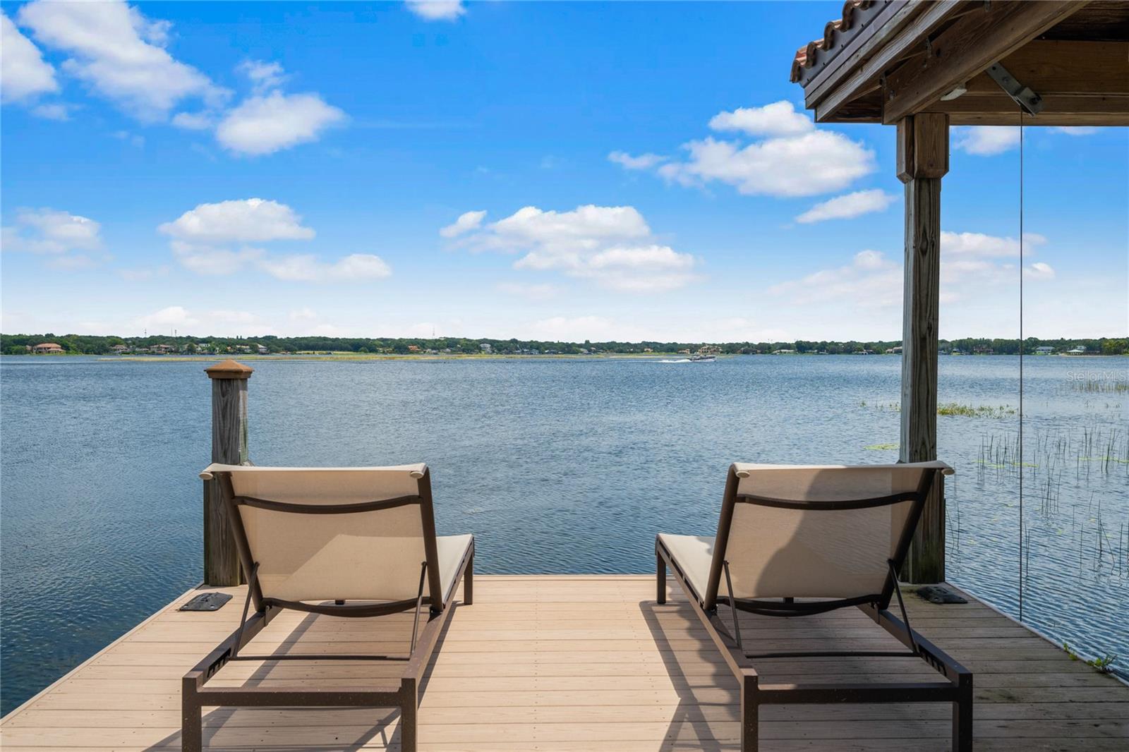 Location Location Location. Set along the shores of Lake Down, part of the Butler Chain of Lakes, this Windermere home offers a rare mix of laid-back lake living with walkability to town, and a bike ride to Windermere Elementary. The Town of Windermere has much to offer. Walk to the local park and tennis courts just a few blocks from your home.  It’s an easy stroll or bike ride to Main Street—home to local spots like Dixie Cream, Paloma Coffee, Windermere Brewing Company, the Friday farmer’s market, and the newly updated shops and dining on the 500 Block.

Inside, the home is both comfortable and thoughtfully updated, with travertine flooring in the main living areas and new luxury vinyl plank in two bedrooms —no carpet. The kitchen features a gas cooktop with vented exhaust, a new Dacor refrigerator and a newer all-in-one convection oven, microwave, and air fryer. The large dining room provides a pleasurable dining experience with lake views. The 4th bedroom/theater room is a flexible space that can be used as a guest bedroom, theatre room, workout room or a game room. It can also work as a large office, playroom, or just a place to sit and relax with views of the lake.

The bright open Florida room, equipped with three full glass French doors with side panels, a wet bar and views of your outdoor lakefront oasis, opens up to the pool and overlooks the water, creating an easy space to relax or entertain. 

A great opportunity to enjoy the convenience of the Butler Chain lifestyle in the heart of Windermere—with no HOA.