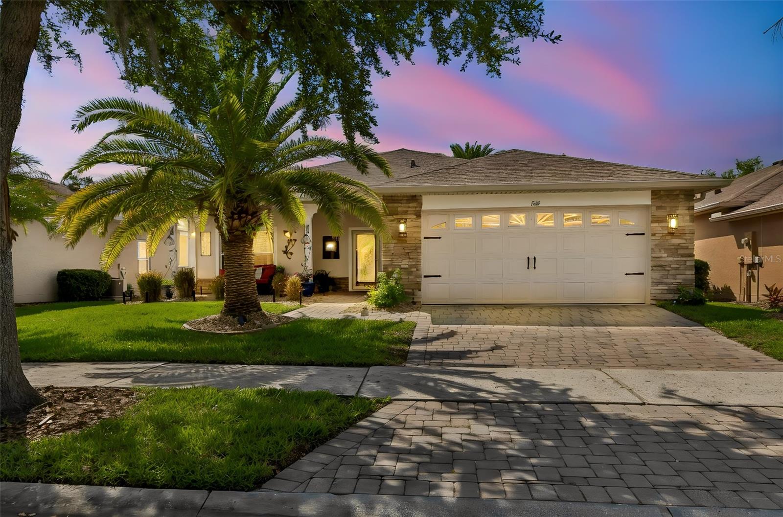Well-maintained Sonata model located in a quiet neighborhood on a lush conservation setting, featuring a 26x20 enclosed lanai with acrylic glass windows and vaulted ceilings. NEW ROOF in 2016, NEW HVAC in 2025, New carpet (2023) and the CDD debt fee has been PAID IN FULL. A welcoming front porch with a leaded glass entry door opens to this spacious home offering 2 bedrooms, 2 bathrooms, plus a den and separate dining room. Triple sliders in the living room open to the oversized lanai, extending your living and entertaining space while showcasing peaceful conservation views. The kitchen features 42-inch staggered solid wood cherry cabinets, Zodiaq quartz countertops, composite sink, newer stainless steel refrigerator and microwave,and slider to the lanai. The spacious owner’s suite flows into the ensuite bath with raised vanities, tiled walk-in shower, knee space and a large walk-in closet. The second bedroom is conveniently located adjacent to a full guest bath. A large storage closet off the hallway provides additional storage space. The front of the home features attractive river rock landscaping and an architectural stone façade, creating exceptional curb appeal. The full two-car garage includes an overhead storage rack. An additional open-air screened and covered patio perfect for grilling. A separate patio is available for outdoor enjoyment. Solivita is a premier 55+ community, offering residents an exceptional lifestyle with state-of-the-art amenities. Enjoy 2 fully equipped fitness centers, dance and aerobics studios, and an impressive array of recreational options including 14 heated swimming pools, two heated spas, tennis courts, pickleball courts, shuffleboard, bocce ball, billiards, and an art gallery. The community also features three on-site restaurants and two championship 18-hole golf courses. With a full calendar of activities and events, there’s always something new to explore and enjoy. This home is conveniently located near a hospital and medical office complex, and shopping center.
