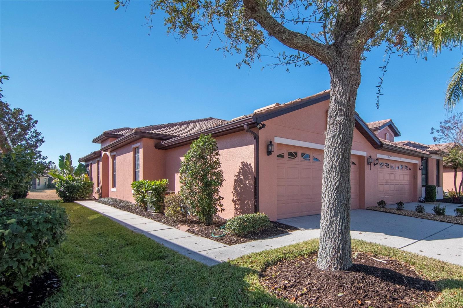 One or more photo(s) has been virtually staged. Welcome to easy coastal living in the vibrant 55+ Del Webb community of Apollo Beach (with a NEW PRICE), where every day feels like a getaway and neighbors quickly become friends. This beautifully maintained two bedroom, two bathroom villa by Centex offers comfortable single level living with a bright, open layout designed for both relaxation and entertaining. A private side entrance welcomes you into a light filled interior featuring ceramic tile throughout the main living areas and seamless flow between the kitchen, dining, and living spaces. The kitchen is perfectly positioned with Corian countertops and ample workspace, making it ideal for everything from casual mornings to hosting guests. A versatile den provides the flexibility for a home office, reading room, or additional guest space, while the spacious primary suite offers a peaceful retreat with a walk in closet and private bath. Everyday convenience is enhanced by an interior laundry room with full size washer and dryer and a two car garage for storage and ease. Step out to the screened lanai and take in tranquil water views across the expansive retention pond, creating the perfect backdrop for morning coffee or evening unwinding. With low monthly HOA fees and no CDD, this home offers true maintenance free living so you can spend more time enjoying the incredible resort style amenities including multiple pools, tennis and pickleball courts, a fitness center, clubhouse, and an active social calendar filled with opportunities to connect and stay engaged. Ideally located between Tampa and Sarasota with convenient access to beaches, dining, shopping, and medical facilities, this is your opportunity to embrace the lifestyle you have been waiting for, so schedule your private showing today and see why so many are choosing to call Del Webb Apollo Beach home.