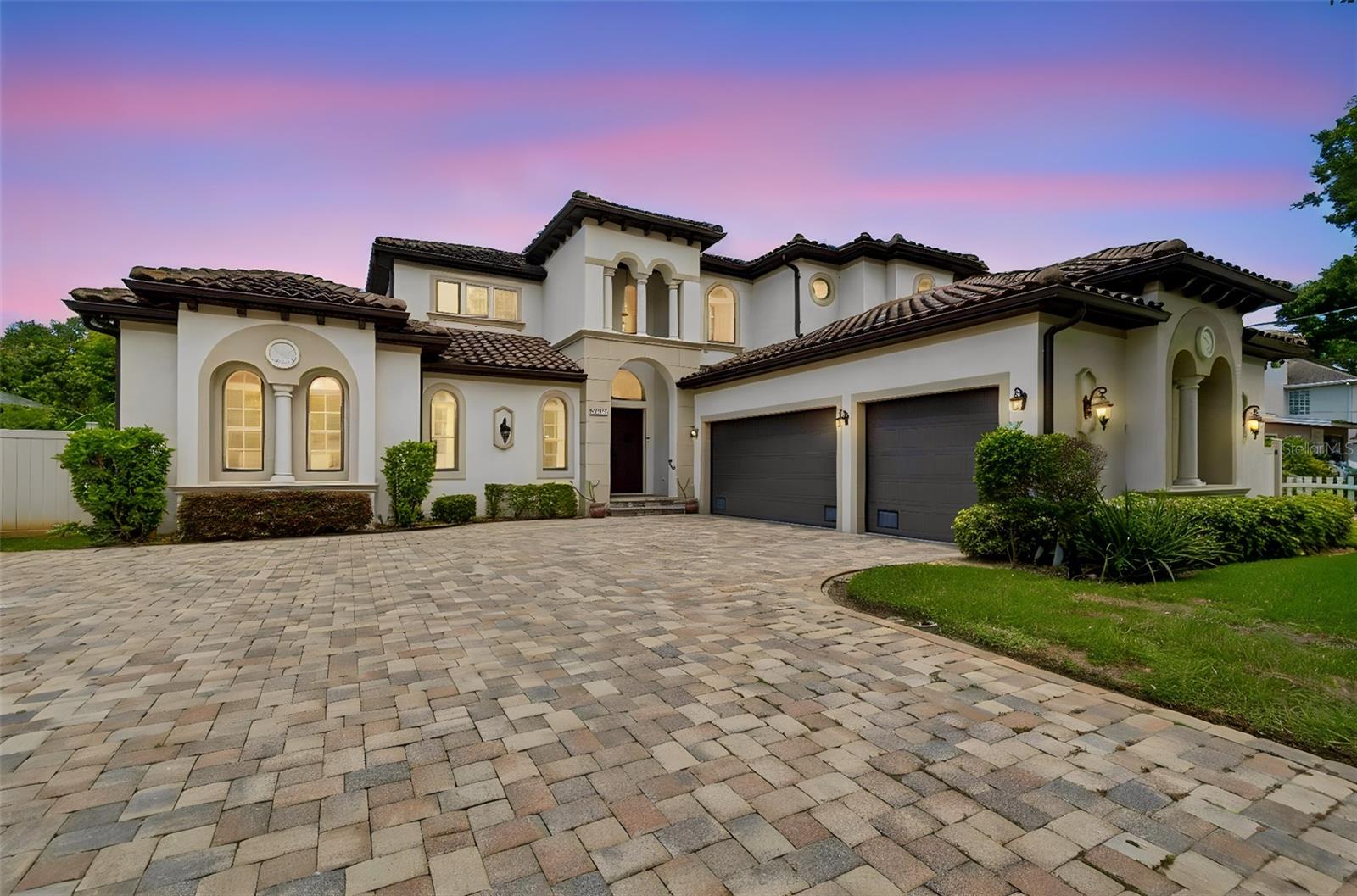 Experience elevated luxury in this custom-designed Modern Spanish Mediterranean estate, where timeless architecture and exceptional craftsmanship create a truly distinctive residence. Featuring a classic barrel tile roof, soaring double-volume ceilings, and abundant natural light from its desirable east-facing orientation, this home seamlessly blends sophisticated design with modern functionality. Exquisite details include 8-inch baseboards, extensive custom crown molding, dramatic arched windows, custom wainscoting, rectified marble and travertine flooring, engineered hardwood, and a stunning wrought-iron staircase accented with authentic Spanish riser tiles.

The gourmet chef’s kitchen is designed to impress, offering a 36-inch Viking gas cooktop, KitchenAid double convection ovens, granite countertops, custom soft-close cabinetry with pull-out pantry, dual spice racks, wine storage, Kohler prep and main sinks, an integrated wine cooler, pot filler, under-cabinet lighting, an oversized center island, and a custom travertine backsplash.

The first-floor primary suite is a private retreat featuring French doors that open to the lanai, an extraordinary 14’ x 14’ custom California walk-in closet with a granite-topped center island, and a spa-inspired bath complete with dual granite vanities, an oversized dual-head walk-in shower, custom travertine finishes, and an expansive custom mirror.

Designed for exceptional indoor-outdoor living, the resort-style lanai offers more than 400 square feet of covered entertaining space with tongue-and-groove Cypress ceilings, three ceiling fans, a fully equipped summer kitchen with stainless steel appliances and a 36-inch gas range, and a custom gas fire feature. The PebbleTec pool and gas-heated spa showcase a dual-overflow design, oversized sun shelf, wireless app-based controls, and a premium Super Screen enclosure.

The upper level features a spacious loft, laundry room, and three generously sized bedrooms with walk-in closets and custom finishes. One bedroom includes a private ensuite bath, while the remaining two share an oversized Jack-and-Jill bath. Additional highlights include a dedicated executive office and an elegant formal dining room.

Meticulously maintained and extensively upgraded, this exceptional residence delivers a rare combination of architectural beauty, refined luxury, and effortless livability—offering an unparalleled lifestyle for the most discerning buyer.