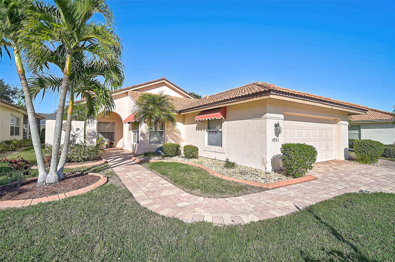 Start the new year in this beautifully maintained 2BR/2BA plus Den patio home located in Peridia Golf & Country Club! The pavered driveway and entry create an inviting first impression. Inside, you are greeted by wood flooring in the entry and great room. The spacious den offers flexibility and is large enough to be converted into a third bedroom if desired. The kitchen features wood cabinetry and granite countertops, with convenient access to an open paver lanai, ideal for outdoor grilling. Additional features include interior laundry with a front-load washer and dryer. The enclosed lanai features freshly painted walls and a cleaned floor, providing a refreshed space for year-round enjoyment. Highlights include a new tile roof (March 2013), updated HVAC (2021), and 240-volt generator wiring. This home offers comfortable living with versatile spaces! Peridia offers a well-established residential setting featuring an 18-hole golf course, tennis and pickleball courts, a community pool, and on-site dining and gathering spaces. A calendar of optional community activities provides opportunities for social interaction and recreation. Association fees include: $938 Quarterly for the Master Association, $337 Quarterly for Yard maintenance, Annual $600 Food/Beverage Minimum, a $100 Admin Fee and a 4,000 One Time Capital Reserve. Don’t miss the opportunity to view this property in person!