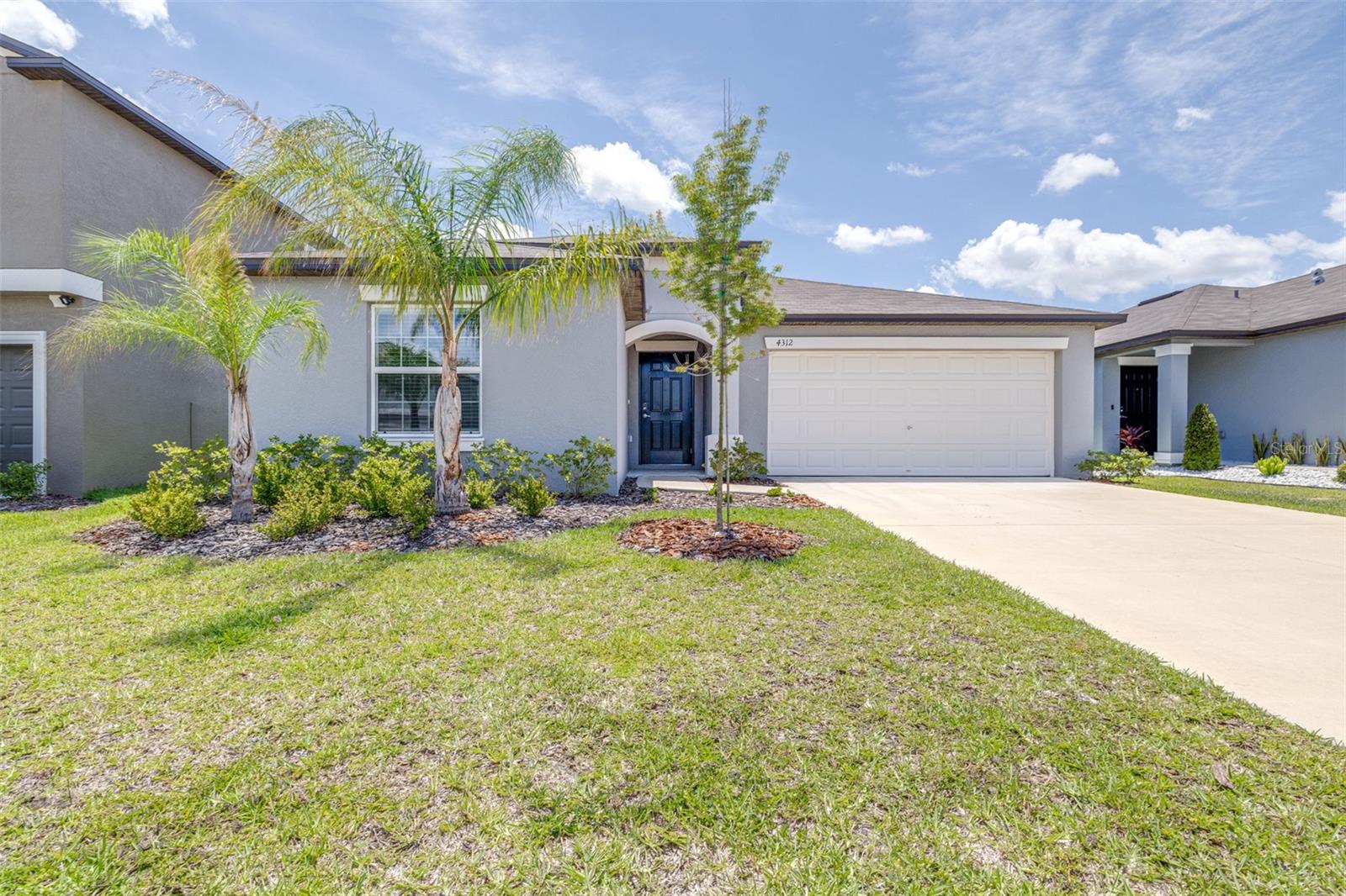 Why wait to build when you can own this move-in ready, like-new 2-year-old home loaded with upgrades? This beautifully maintained single-story residence features an open-concept floor plan where the family room, dining area, and kitchen flow seamlessly together, creating a warm and inviting space for everyday living and entertaining. The kitchen showcases beautiful cabinetry, stainless steel appliances, sleek granite countertops, a large walk-in pantry, garbage disposal, and a reverse osmosis drinking water system. Additional upgrades include a whole-home water softener and filtration system, along with a fully fenced oversized backyard. The spacious owner’s suite is thoughtfully separated from the three secondary bedrooms and features dual sinks, granite countertops, a tiled walk-in shower, and an oversized walk-in closet. A two-car garage provides ample storage and convenience. Residents of Wind Meadows South enjoy resort-style amenities including a community pool, dog parks, playgrounds, and walking paths. Conveniently located near historic downtown Bartow, shopping, dining, parks, lakes, golf courses, and LEGOLAND Florida Resort, with easy access to Lakeland, Winter Haven, Tampa, and Orlando, this home offers the perfect combination of modern comfort, upgrades, and location. Leased solar panels provide energy savings with a current lease payment of $119 per month. Buyer to assume solar lease, subject to solar company approval.
