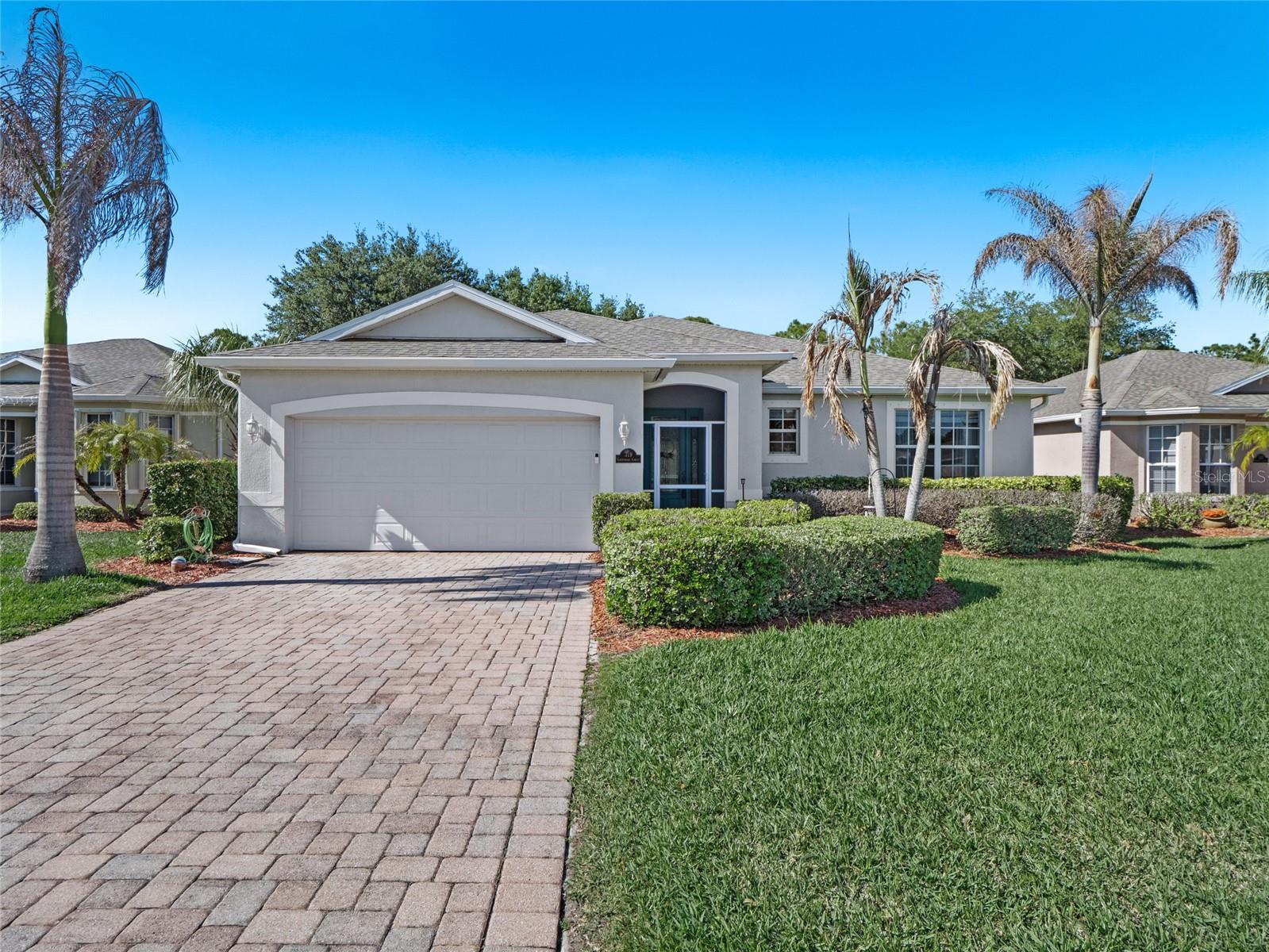 Some homes follow the formula. This one rewrites it. Tucked inside the gated Bayside Lakes community near shops, dining, and daily conveniences, this 3BR/2BA residence offers something the neighborhood rarely delivers: character. The paver driveway sets the tone before you've even stepped inside — polished and intentional, unlike anything else on the street.
Step through the front door and the difference is immediate. Open, airy, and unmistakably its own, the great room flows naturally into surrounding spaces, anchored by wood-look tile that runs seamlessly through every main living area and bedroom. No carpet anywhere means clean, cohesive living without the upkeep.
At the heart of it all is a chef's kitchen that commands attention — generous in scale, thoughtfully executed, and loaded with personality. Glass-display upper cabinets, a dedicated workstation, center island, and breakfast bar make it equally suited for serious cooking and effortless entertaining. A separate dining area just off the kitchen is the kind of space that quietly becomes the center of daily life, perfect for lingering over meals and long conversations.
The owner's suite is a genuine retreat. A bay window floods the room with natural light and creates an organic sitting area, while his-and-her walk-in closets deliver the kind of storage that eliminates compromise entirely.
Step outside and the screened porch earns its place — framing a view of mature trees and open sky that brings a rare kind of stillness. Morning coffee or an evening wind-down, this backdrop is the sort of peaceful that simply cannot be manufactured.
Gated, well-located, and refreshingly distinct — this is not the floor plan you've toured a dozen times. This one is worth your time.