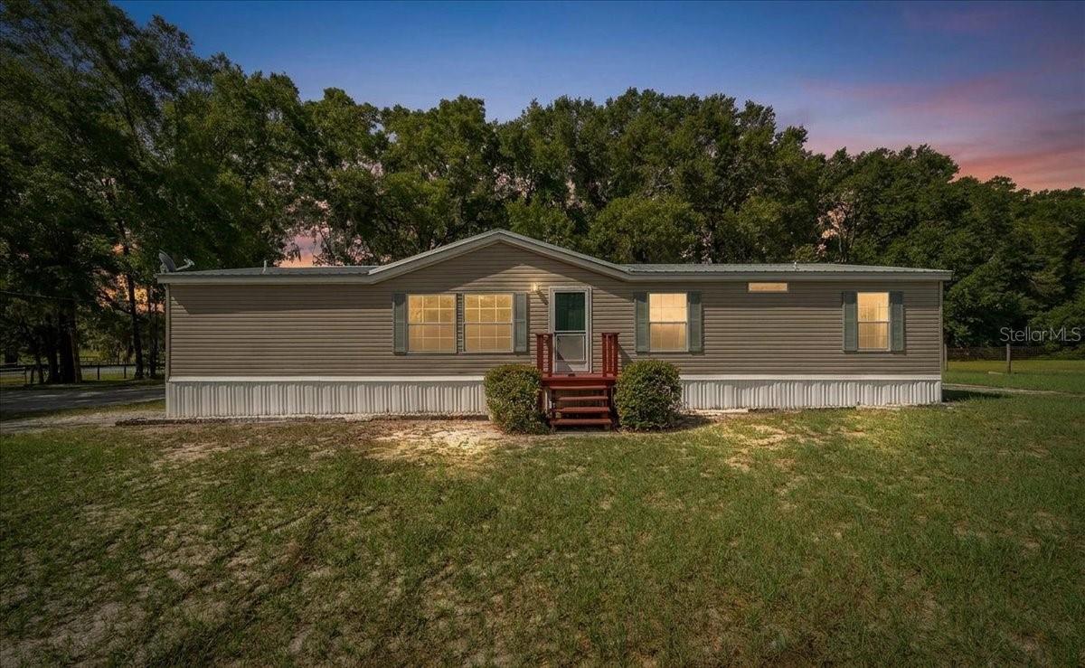 Welcome to your own slice of country living! Situated on 1.59 acres on a desirable corner lot with two separate driveway entrances, this 3-bedroom, 2-bath manufactured home offers 1,620 square feet of comfortable living space with room to spread out, both inside and out.
Step inside to a freshly painted interior and a spacious living room featuring a wood-burning fireplace with built-in bookshelves that create a beautiful focal point. The large kitchen offers an abundance of cabinet space, a built-in stereo system with speakers throughout the main living area and primary suite, and plenty of space for an eat-in kitchen table. A dedicated dining room provides additional room for entertaining family and friends.
Recent updates include brand-new tile flooring in the kitchen, laundry area, and both bathrooms, along with brand-new carpet in the primary and guest bedrooms. Laminate flooring flows throughout the living and dining rooms for easy maintenance.
The spacious primary suite is designed with comfort in mind, featuring a large bedroom, generous closet space, and an ensuite bathroom complete with a soaking tub, separate shower, linen closet, and an additional closet. The two guest bedrooms also offer large closets and brand-new carpet, while the guest bathroom features brand-new tile flooring.
Outside, enjoy the oversized deck, perfect for relaxing or entertaining. A large wooden carport provides ample covered parking for multiple vehicles, trailers, tractors, or recreational equipment.
Equestrians and hobby farmers will appreciate the barn with three stalls, a tack/tool room, a feed room, and a fenced pasture ready for horses or your farm animals of choice. With 1.59 acres, there's still plenty of room to plant a garden, expand the pasture, or even add a pool.
If you've been searching for peaceful country living with the space and amenities to make it your own, this Anthony property is ready to welcome you home.