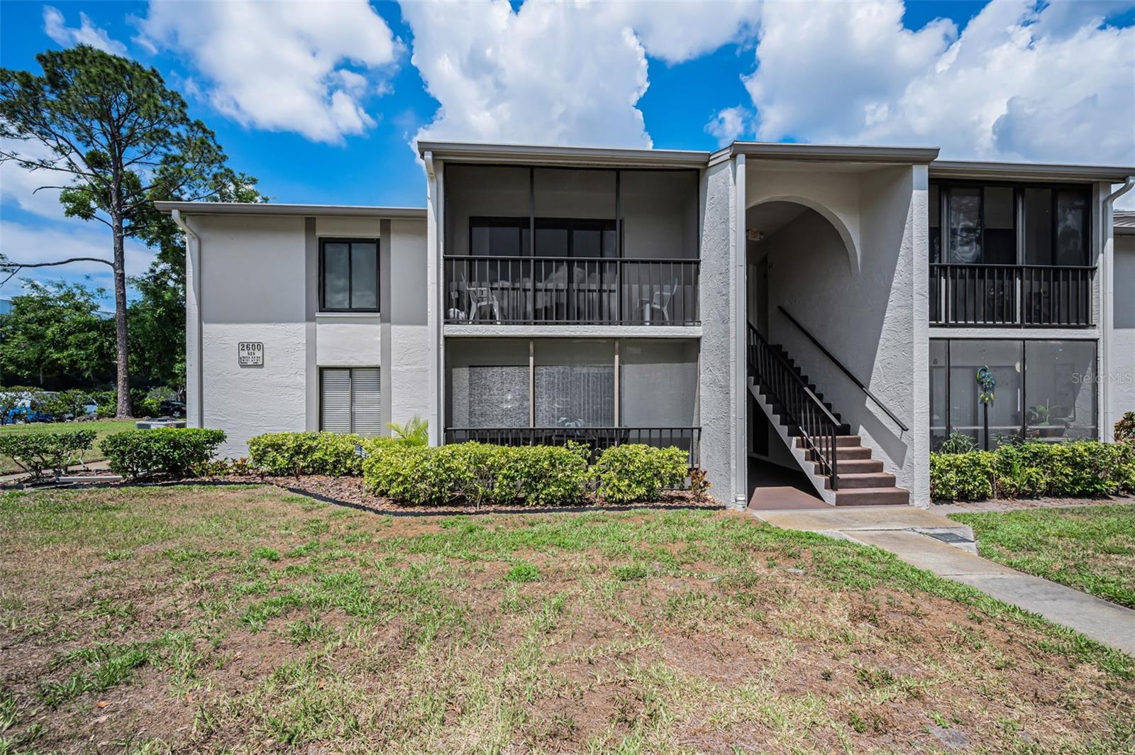ENJOY Easy, Maintenance-Free Living in the Highly Desirable Pine Ridge at Palm Harbor 55+ Community! This Beautifully Maintained Second-Floor Condo offers 2 Bedrooms, 1 Bathroom, and a relaxed Florida Lifestyle Perfect for year-round living or a seasonal retreat. One small domestic Pet is welcome (up to 25 lbs). The Spacious Primary Bedroom is filled with Natural lLght and features a Walk-in Closet, while the Open Living area showcases NEWER Luxury Vinyl Plank Flooring installed in November 2025. The kitchen features Classic White raised-panel Cabinetry, and All Appliances—including the Washer and Dryer—will Convey with the sale. Just off the Kitchen, you’ll find a convenient interior laundry room and a tiled, Screened-in Patio ideal for enjoying Florida’s warm breezes year-round. Additional Updates include NEWER WINDOWS, INTERIOR DOORS, a recently Painted Exterior Building (March 2026), and a NEWER ROOF! The Bathroom includes a Tub/Shower combination and a linen closet for extra storage. Furnishings are Negotiable, making this home truly move-in ready. Residents of Pine Ridge enjoy an Active, Pet-Friendly Community atmosphere with Outstanding Amenities including a HEATED POOL and SPA, Clubhouse, Shuffleboard Courts, BBQ area, and a full calendar of Social Events and Activities. The LOW Monthly Condo Fee offers exceptional value and Includes Exterior and Grounds Maintenance, Roof Maintenance, Escrow Reserves, Water, Sewer, Trash, Cable, and high-speed Internet. Conveniently located near Shopping, Restaurants, Theaters, Medical facilities, Airports, and some of the area’s most Beautiful Gulf beaches, including Honeymoon Island State Park and Caladesi Island State Park, this home offers the BEST of Florida Living. Whether you’re searching for a winter Getaway, Investment Opportunity, or Full-Time Residence, this charming condo is a MUST SEE! Schedule your private showing TODAY!!!